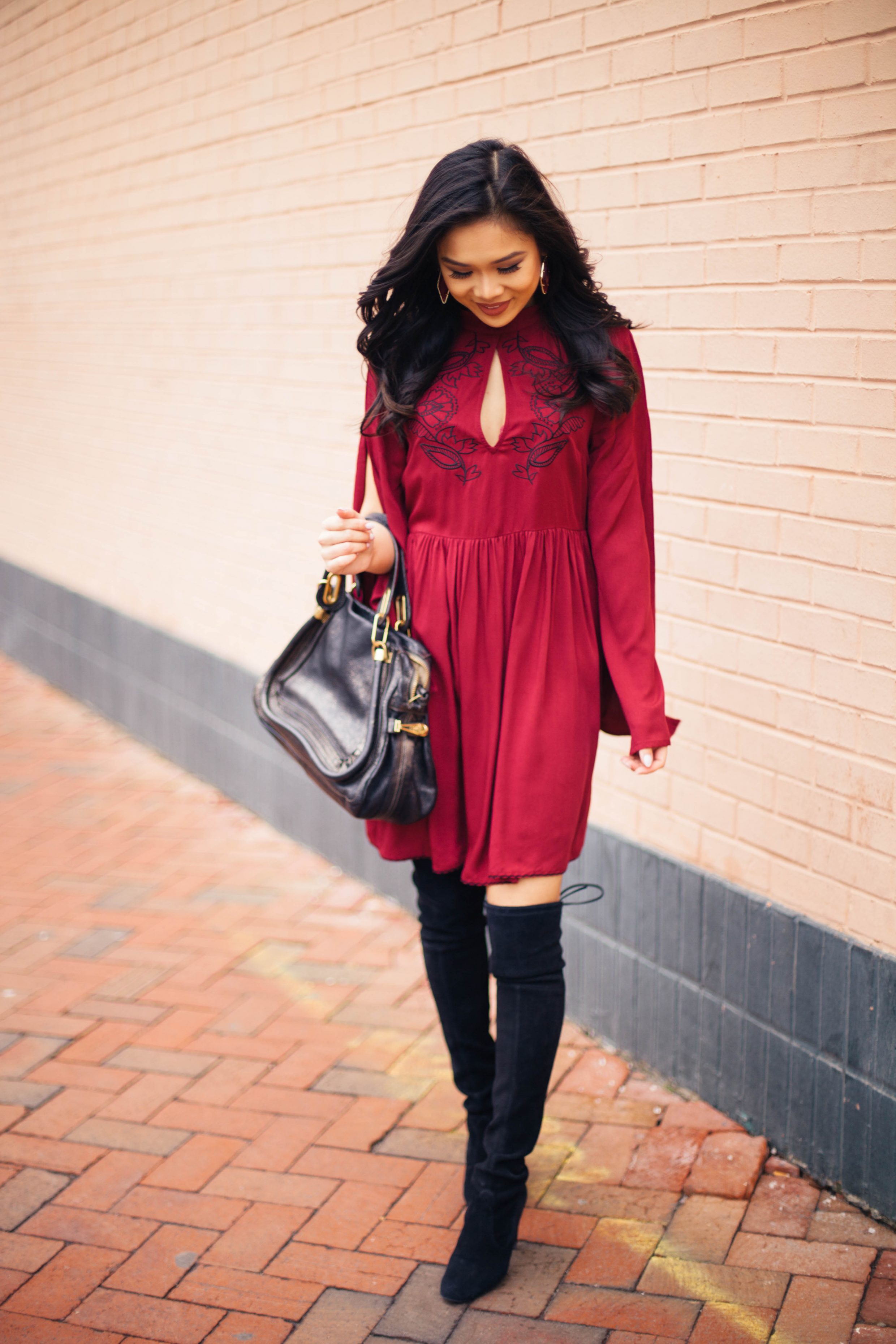 Blogger Hoang-Kim wears a MINKPINK Valley of the Vine embroidered dress in wine red with over the knee boots