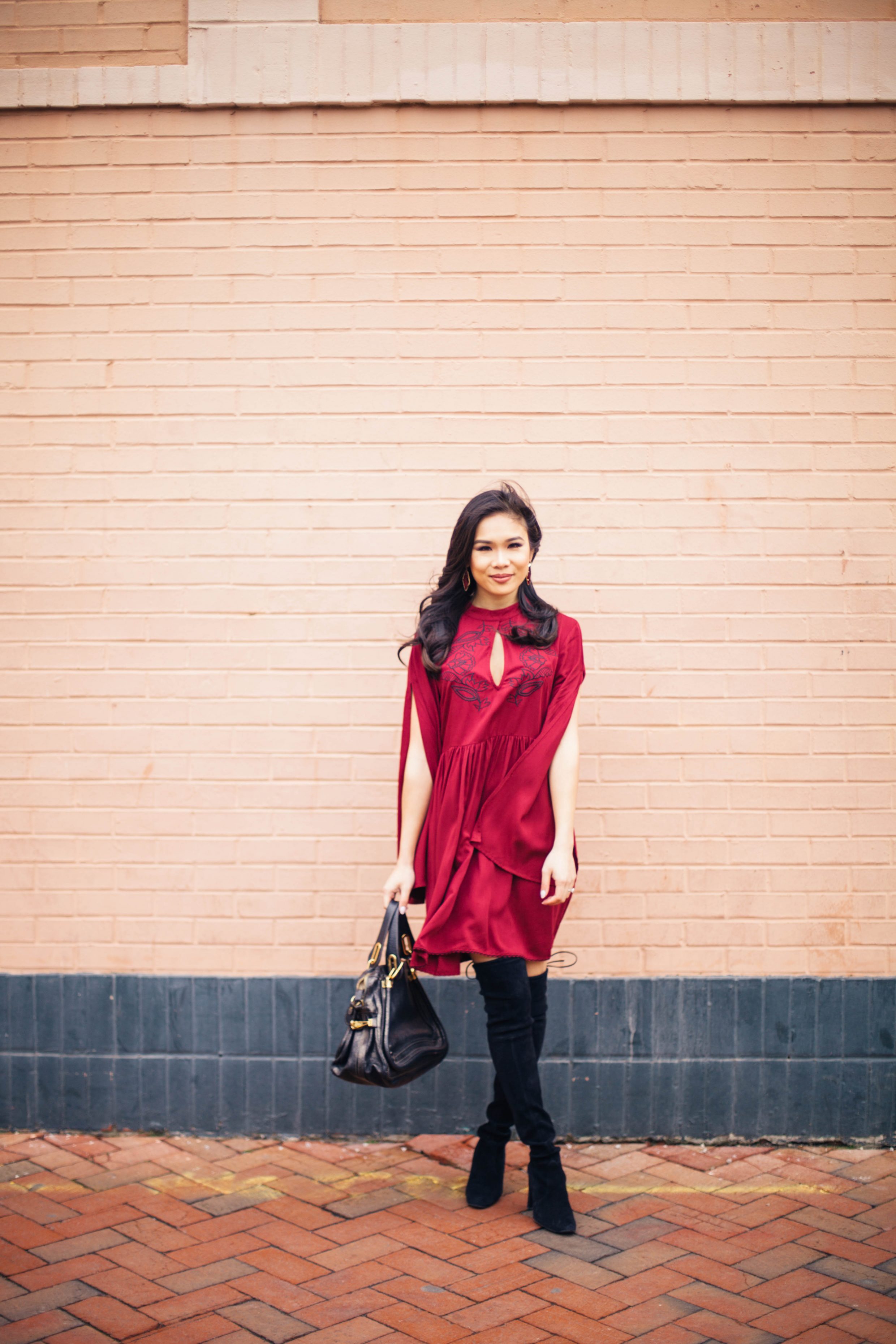 Blogger Hoang-Kim wears a MINKPINK Valley of the Vine embroidered dress in wine red with over the knee boots