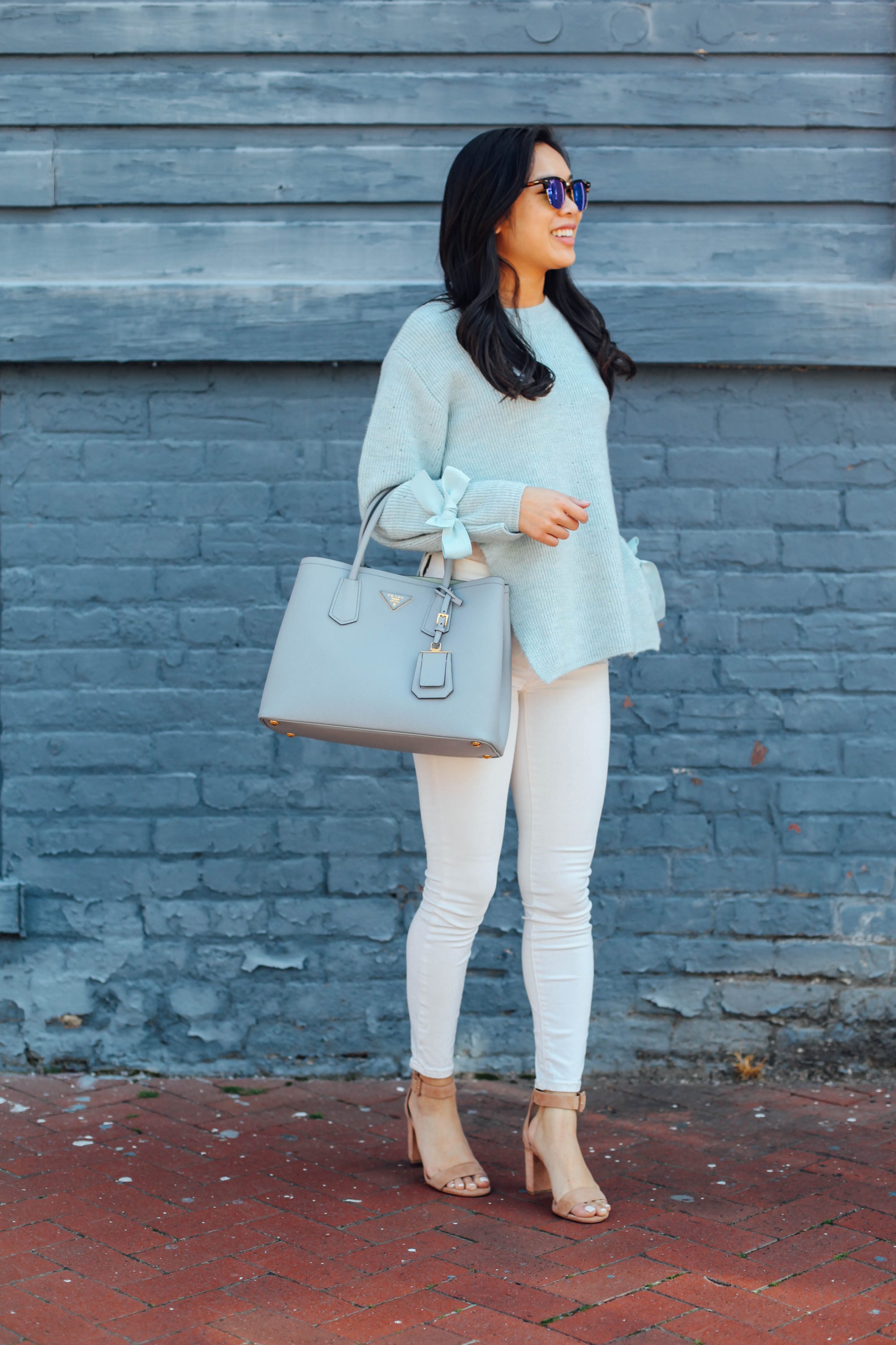 Blogger Hoang-Kim wears a Topshop bow sleeve sweater with suede sandals