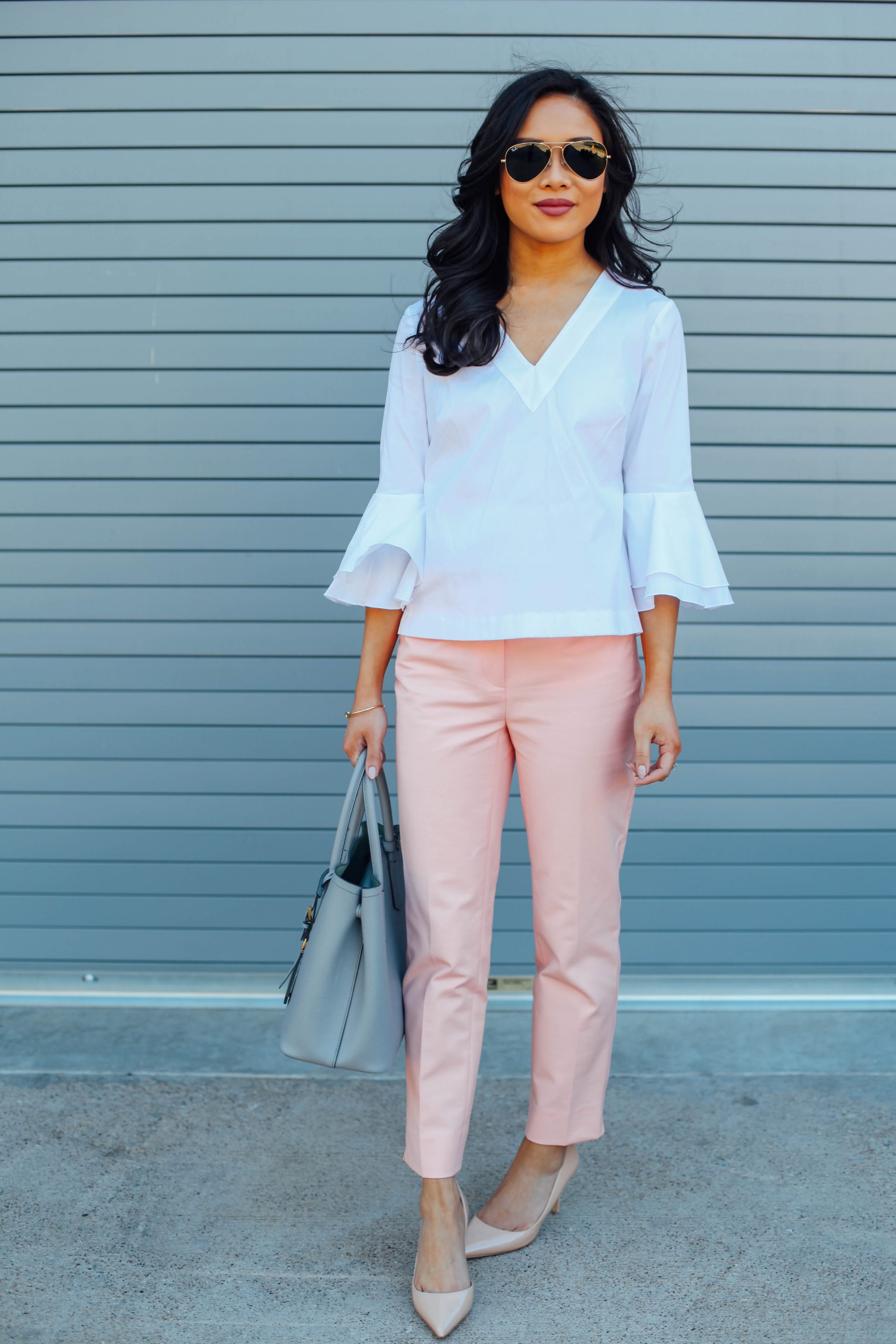 Blogger Hoang-Kim wears a bell sleeve poplin blouse with pink ankle pants