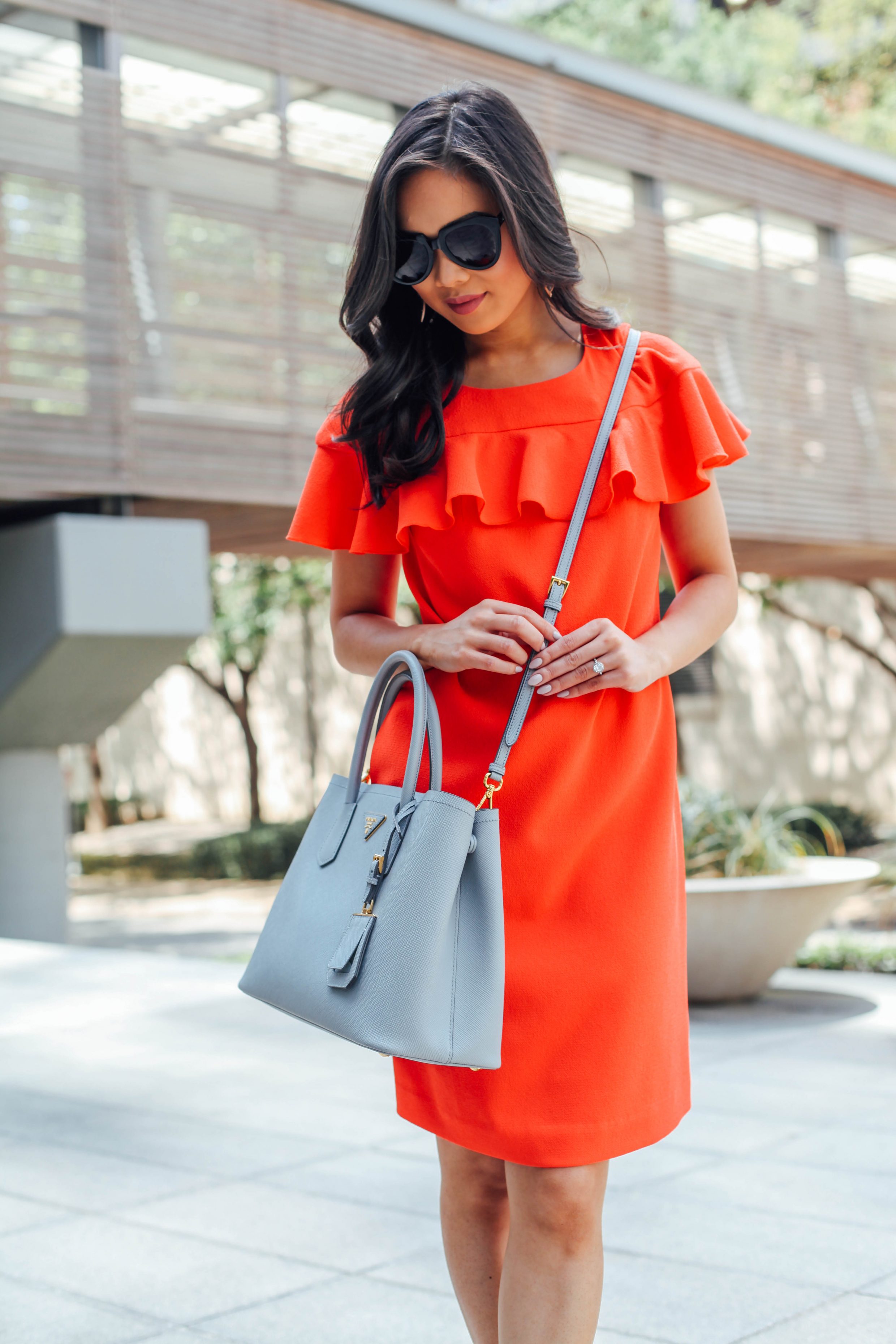 Blogger Hoang-Kim wears a bright orange ruffle dress for spring