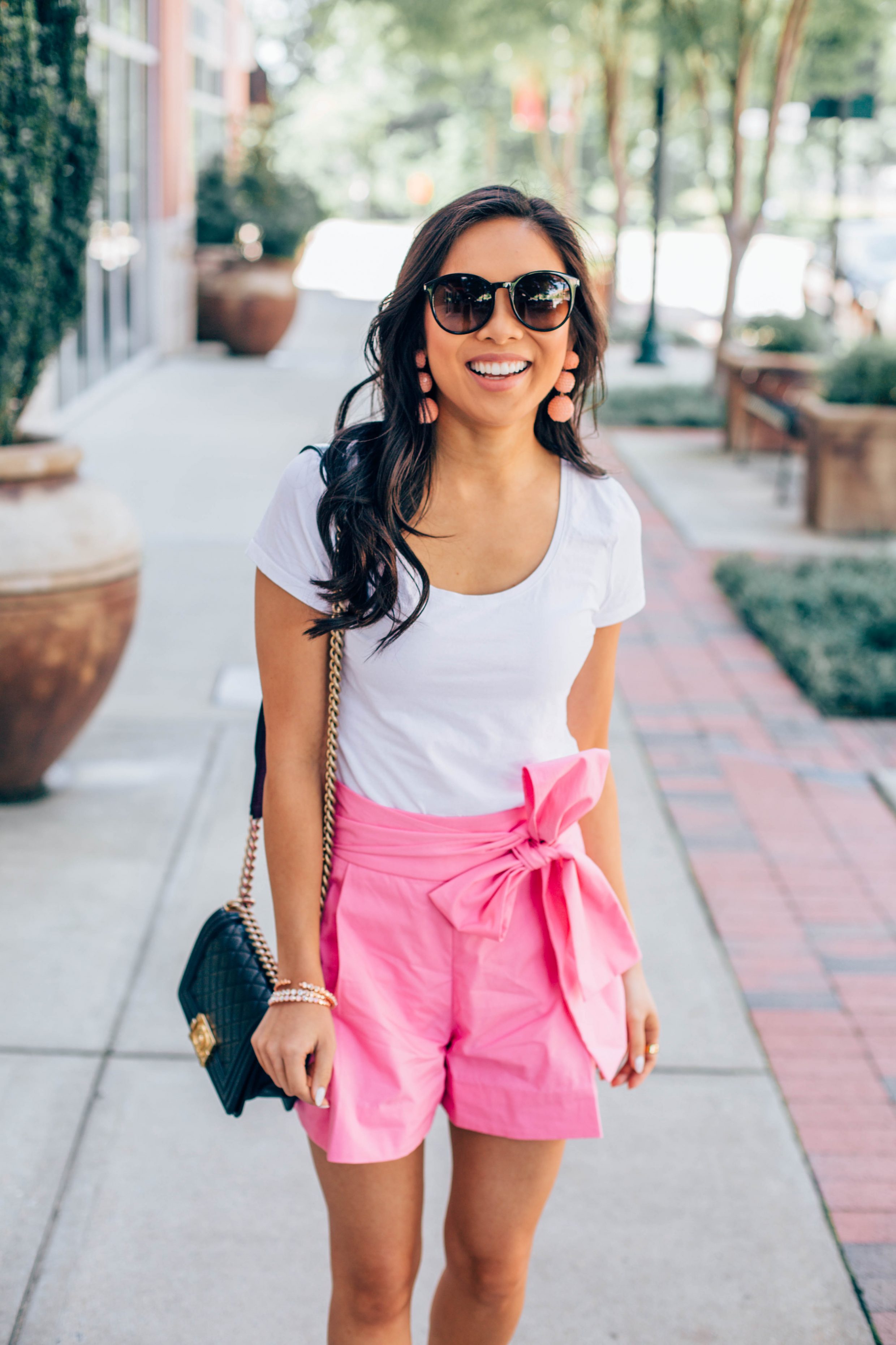 COLOR & CHIC | Summer outfit idea: pink tie-waist shorts with a white tee and sequin drop earrings