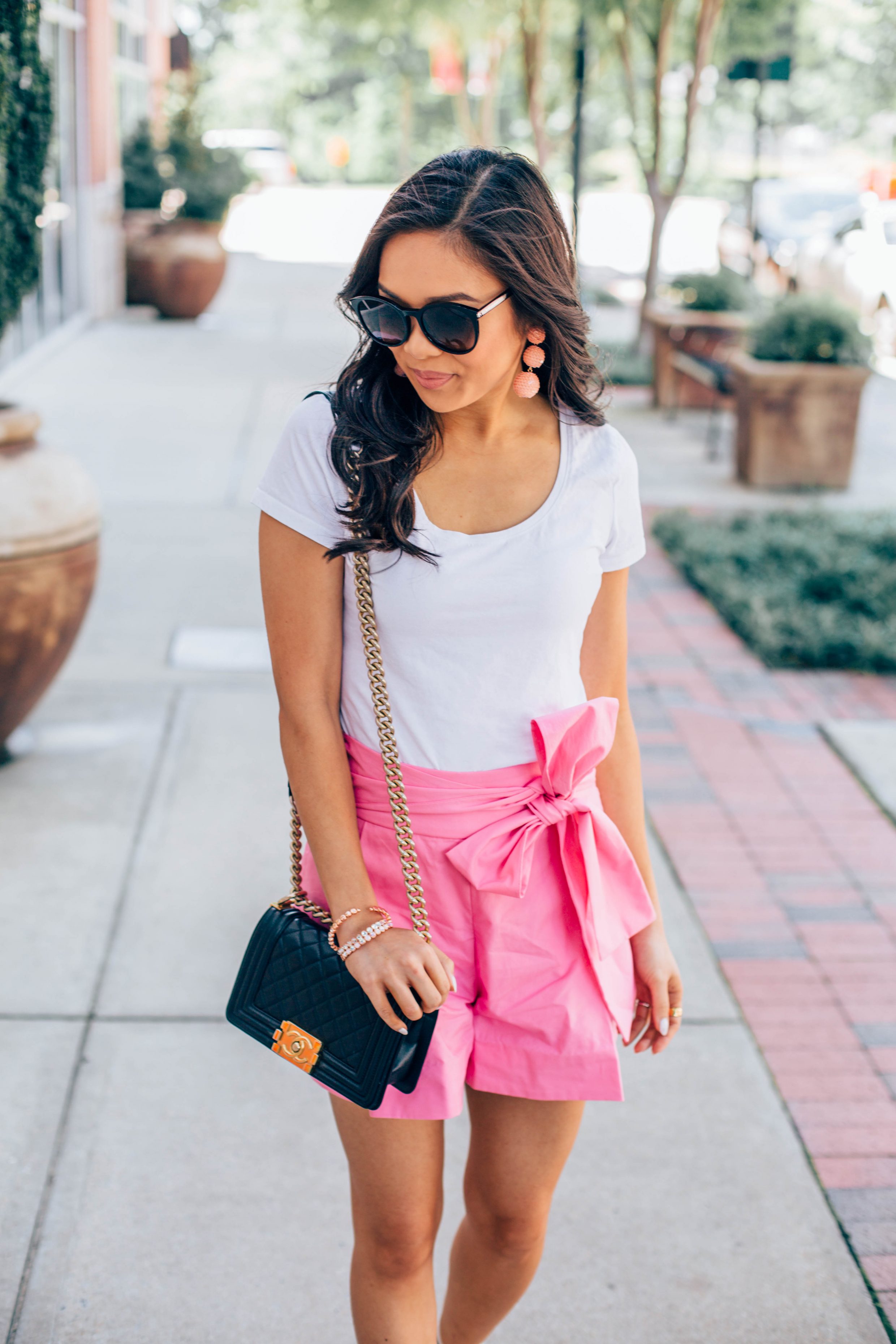 COLOR & CHIC | Summer outfit idea: pink tie-waist shorts with a white tee and sequin drop earrings