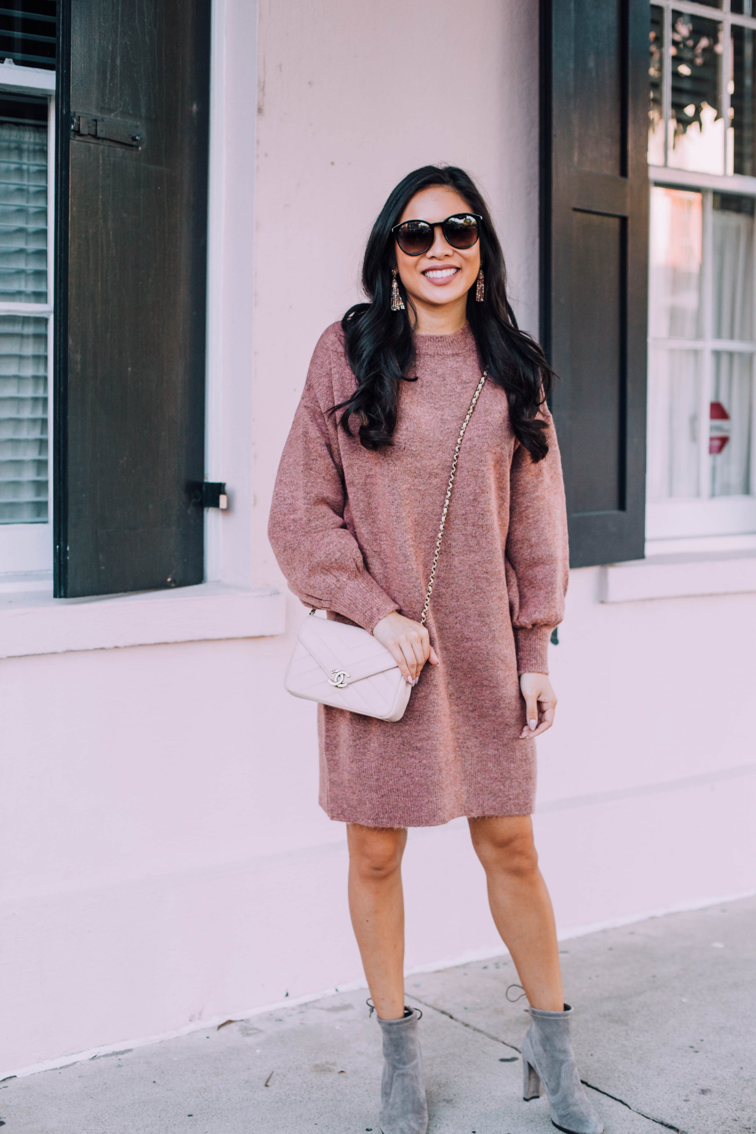 Mauve sweater dress and gray booties with Chanel bag and Baublebar tassel earrings
