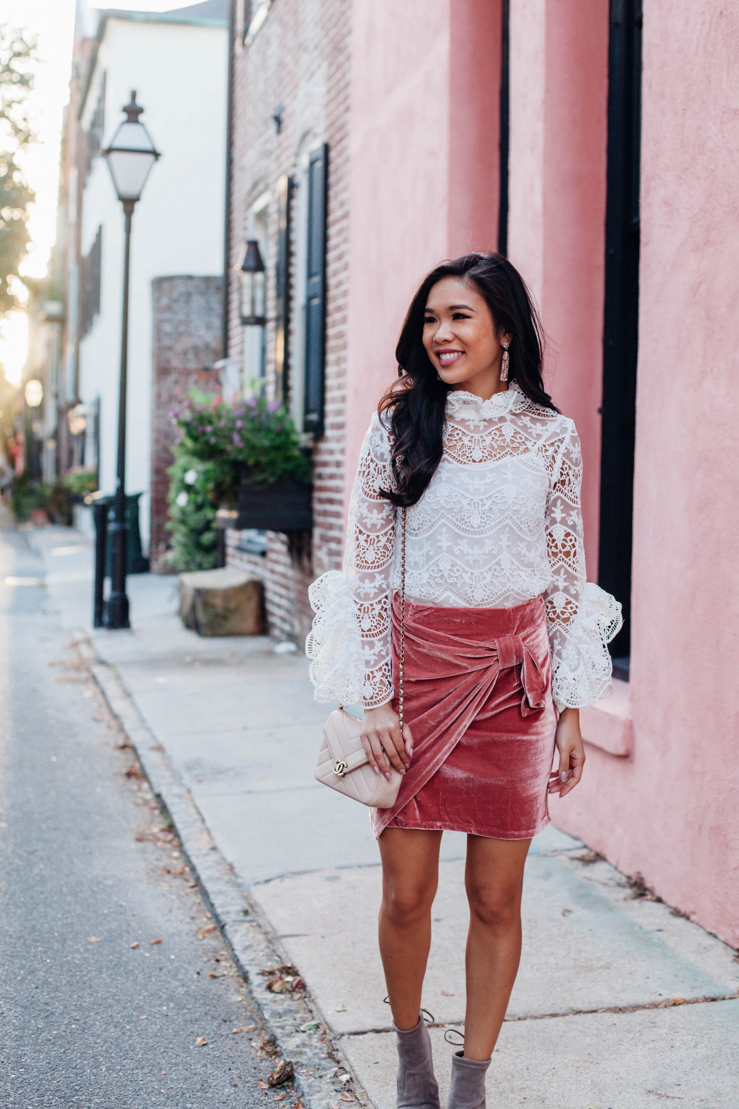 Lace crochet blouse and pink velvet skirt with Chanel bag