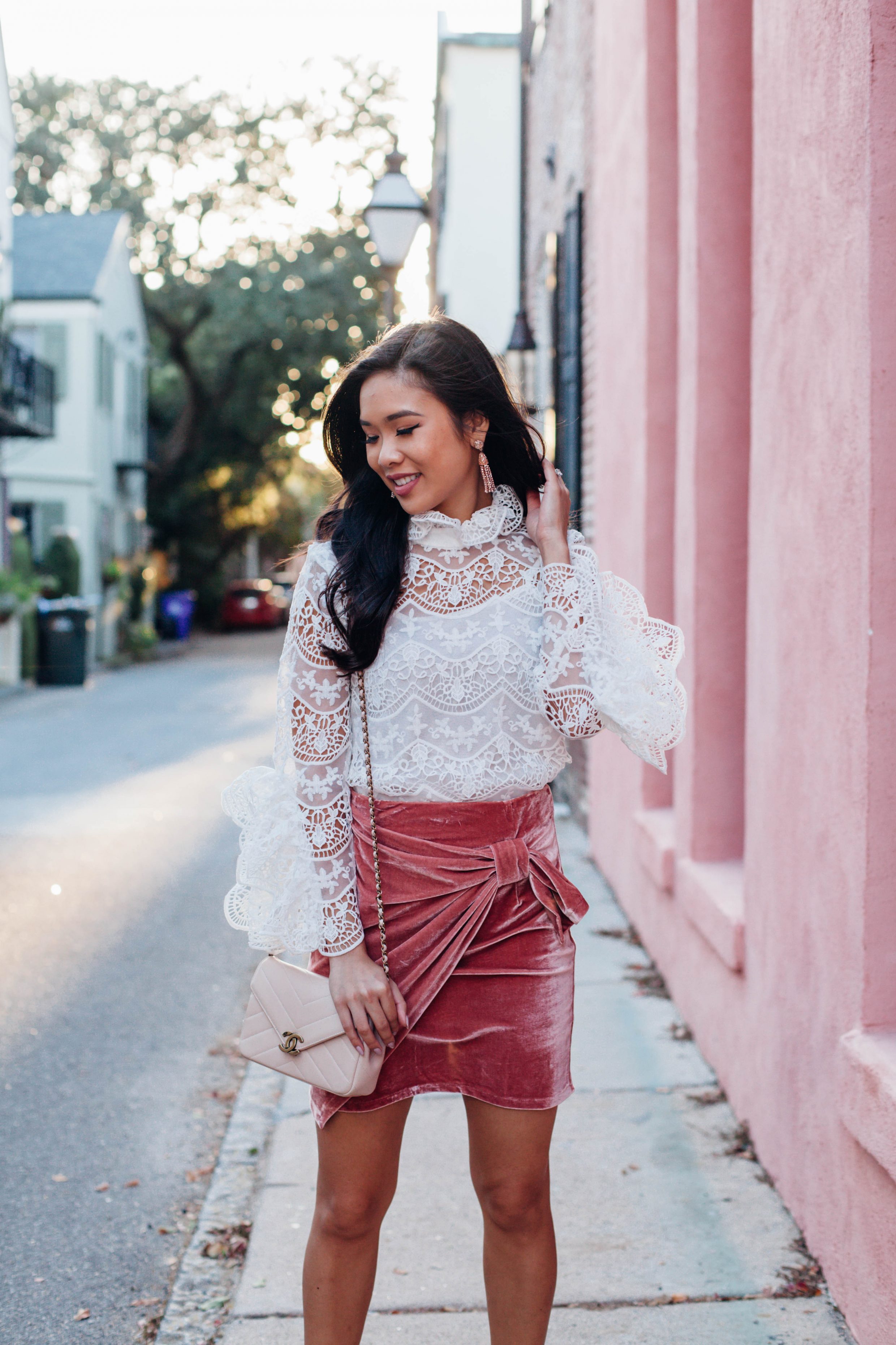 Lace crochet blouse and pink velvet skirt with Chanel bag