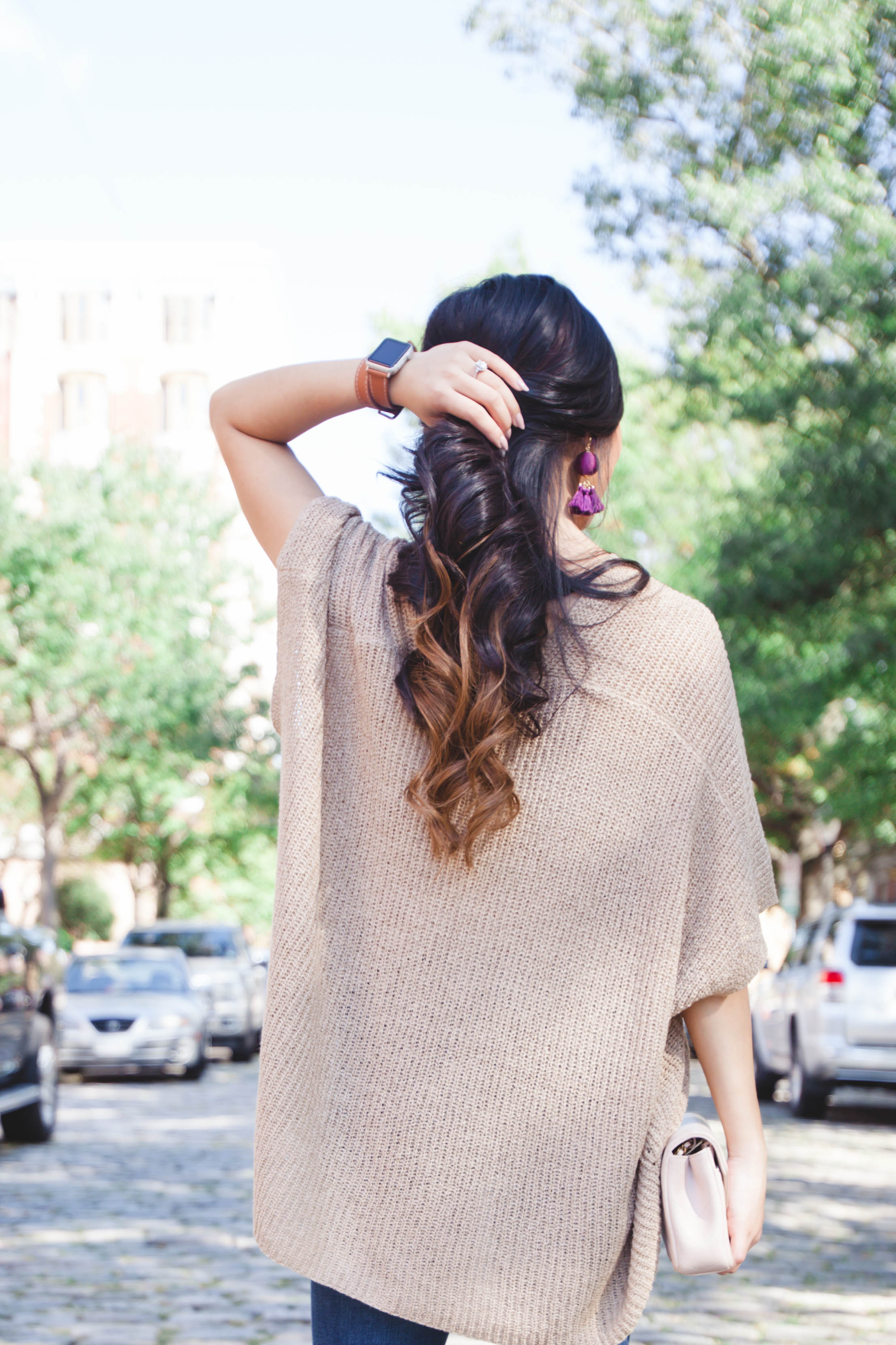 Tan lightweight sweater with plum earrings and Chanel bag