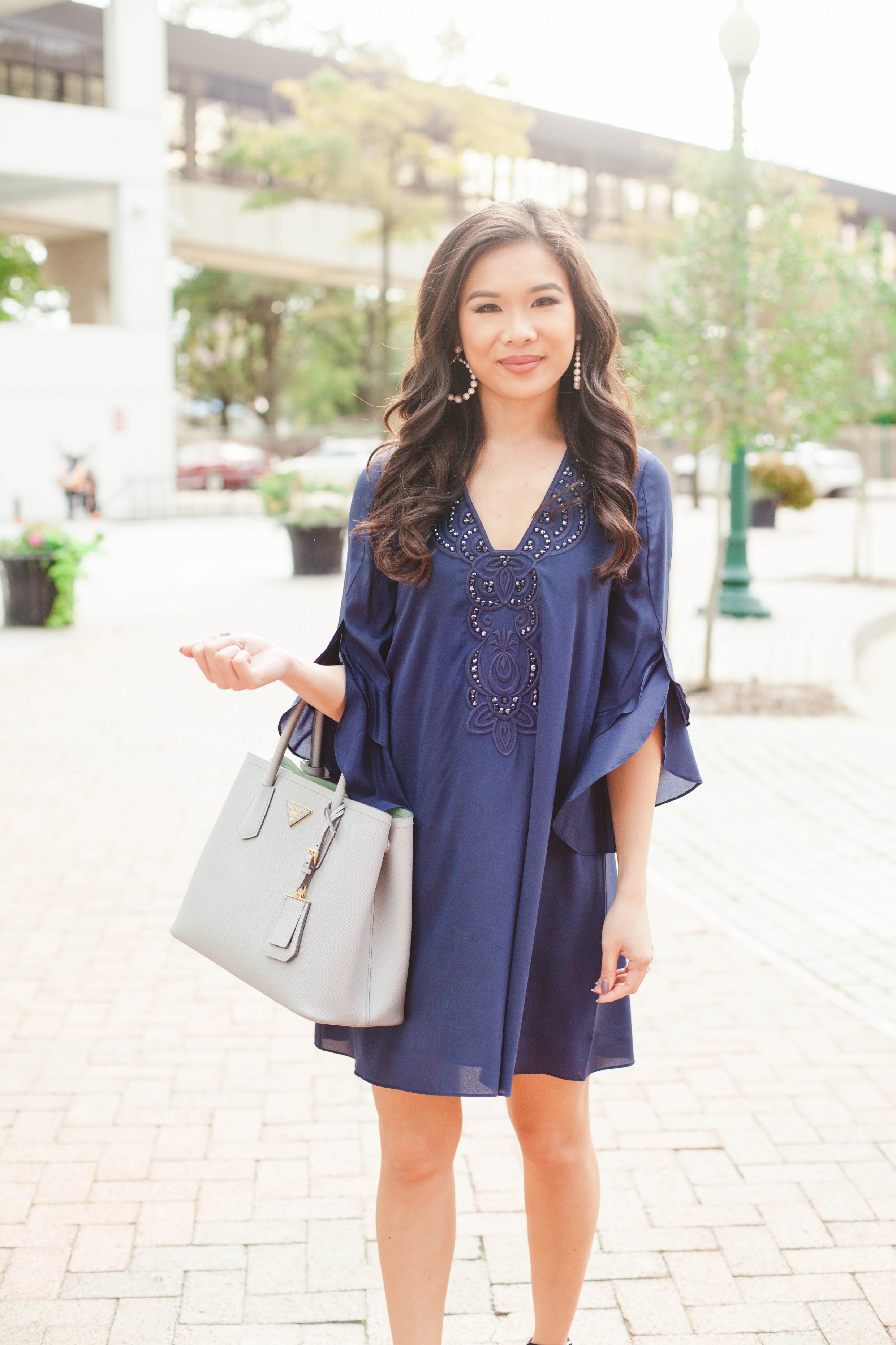 Navy blue silk tunic dress with layered sleeves and Prada Cuir tote