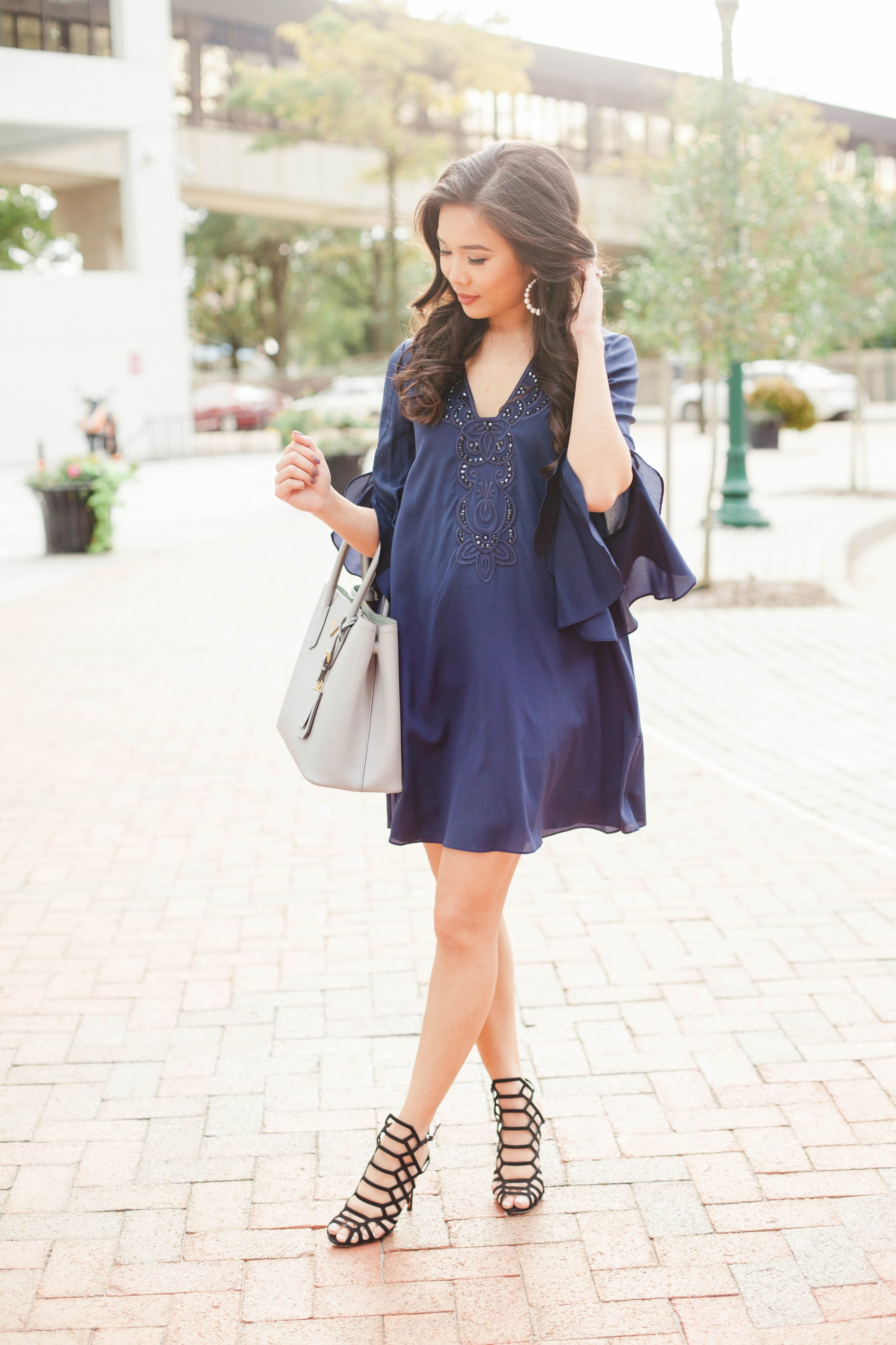 Navy blue silk tunic dress with layered sleeves and cage heels
