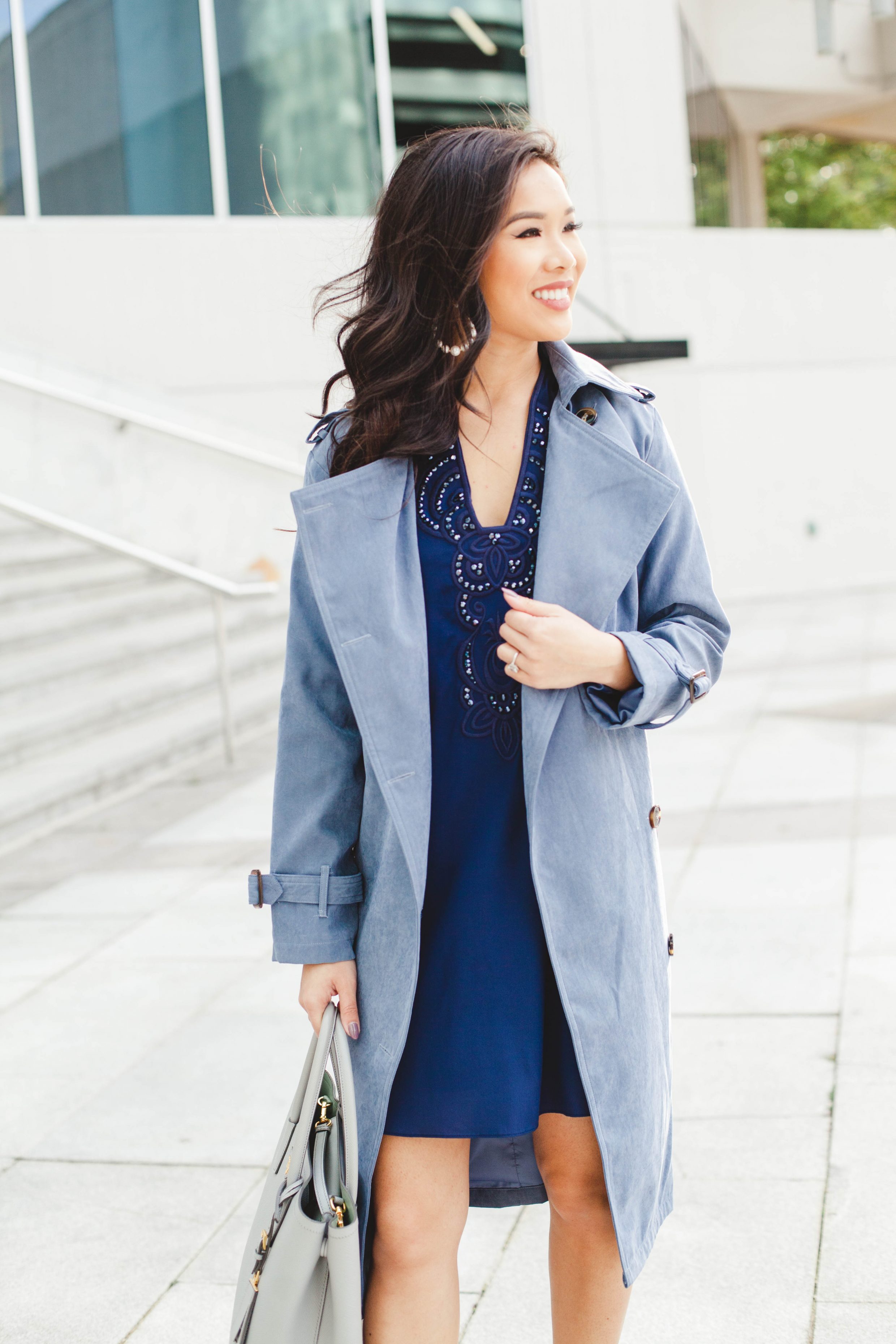 Navy blue silk tunic dress and dusty blue trench coat for holiday parties