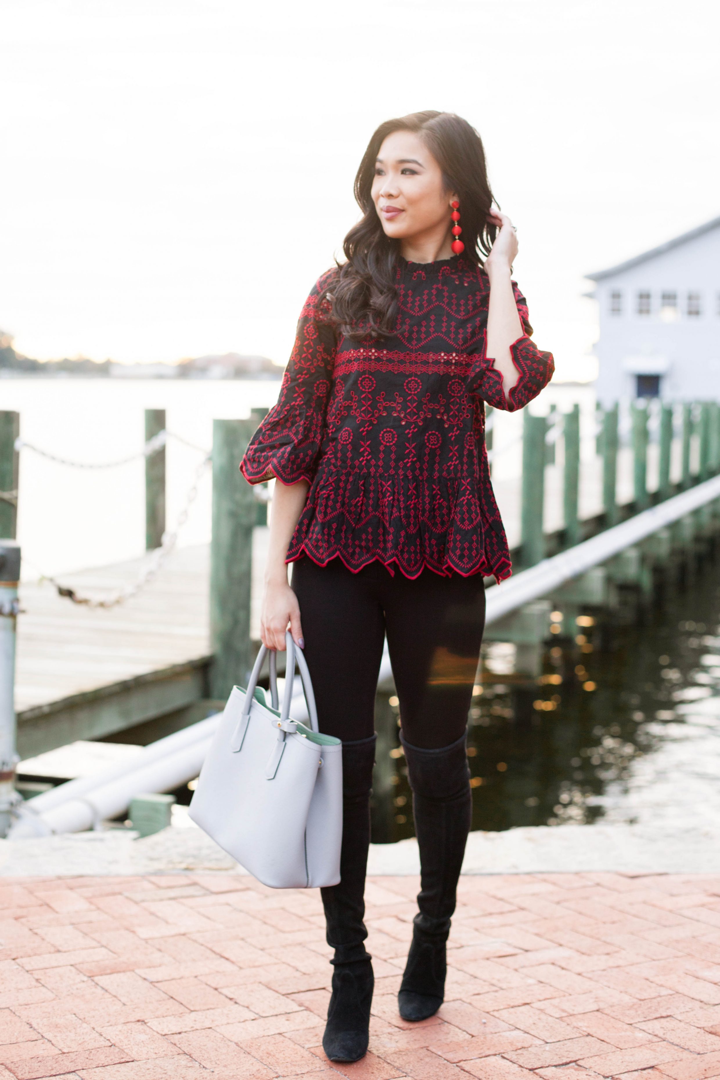 Red embroidered top with black over the knee boots for the holidays