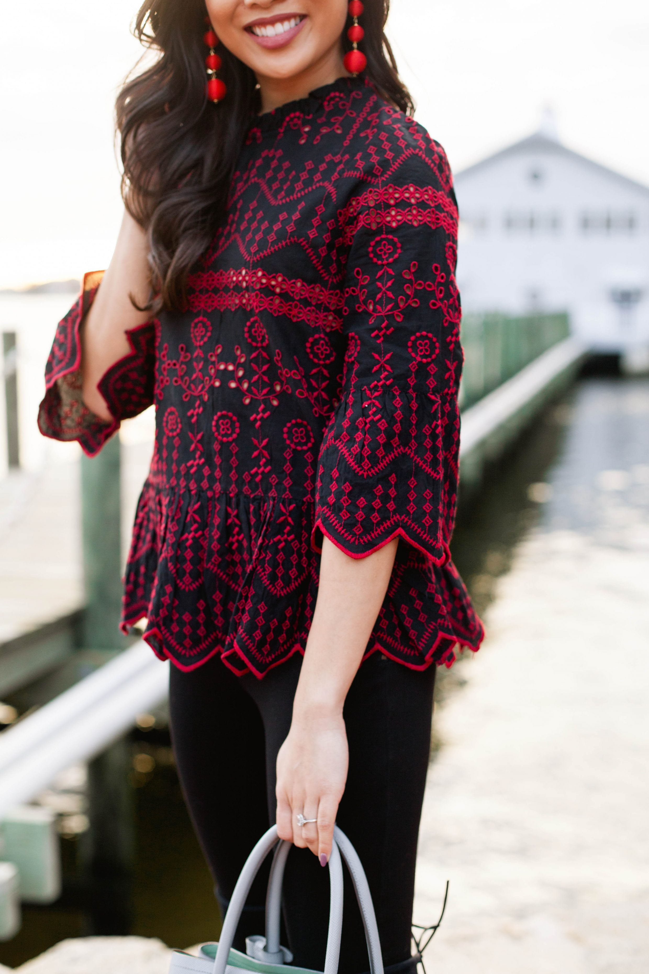 Red embroidered top with black over the knee boots for the holidays