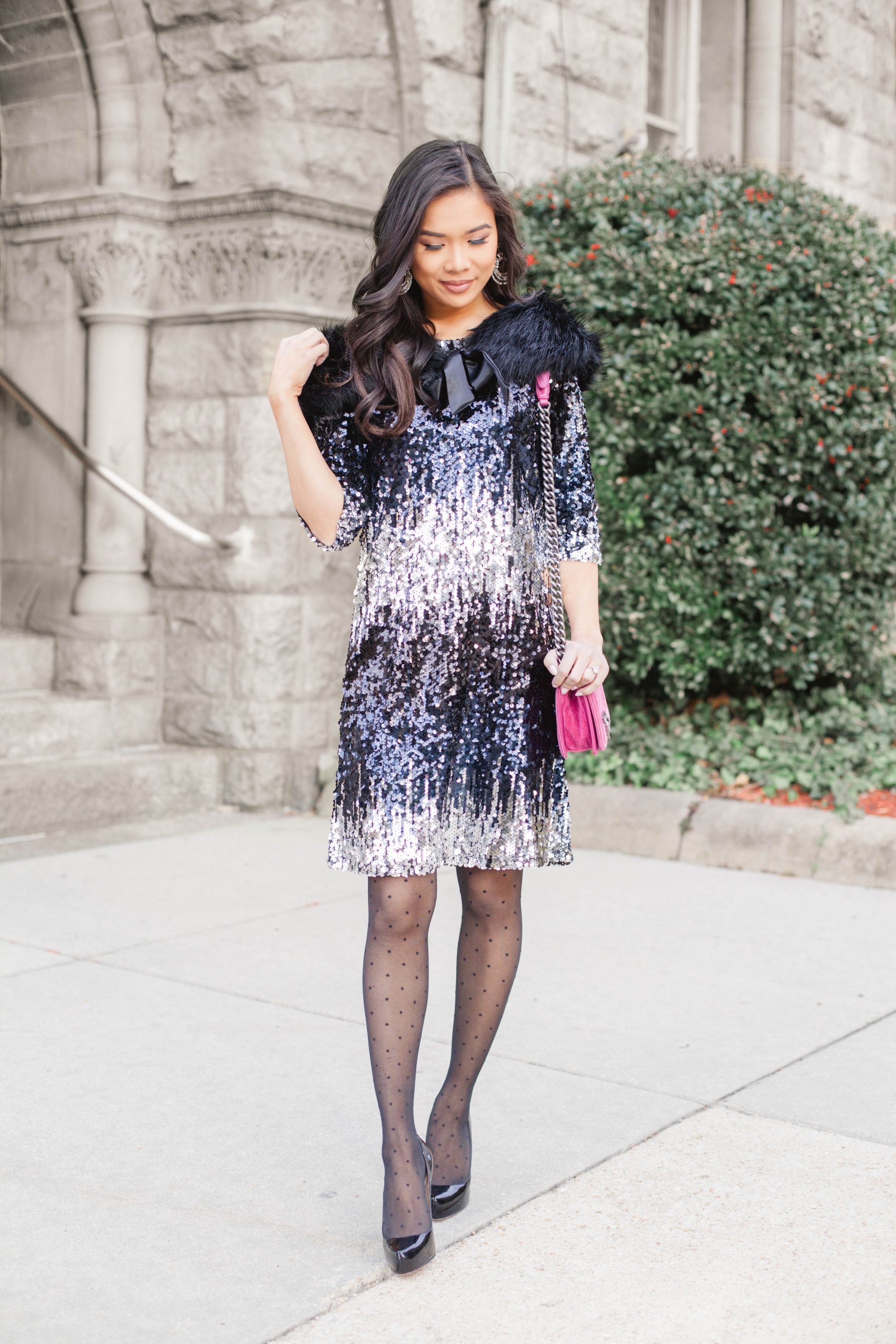 Holiday glam look with a sequin dress, faux fur stole and dotted tights