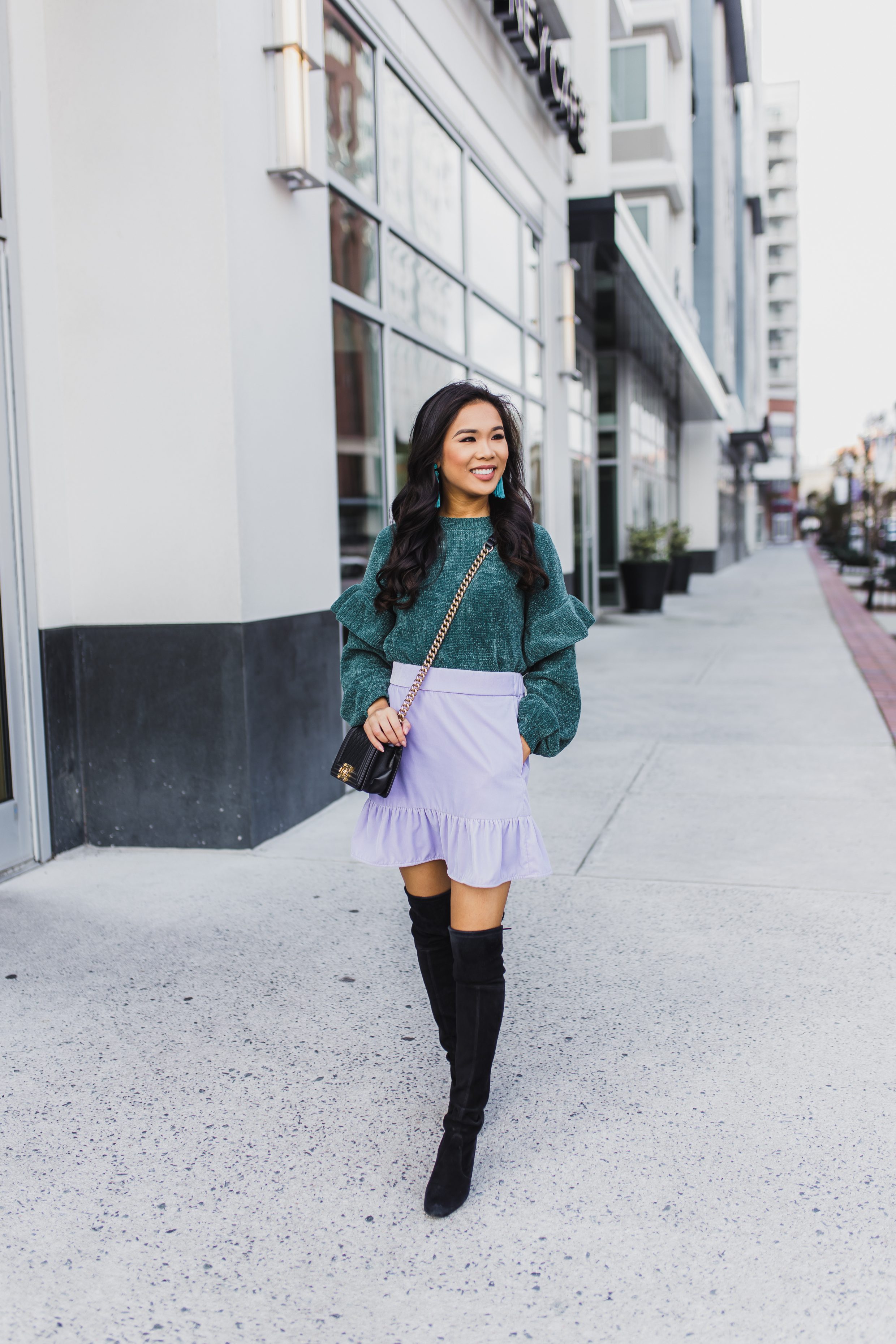 Chenille sweater with ruffle detail paired with velvet skirt and over the knee boots
