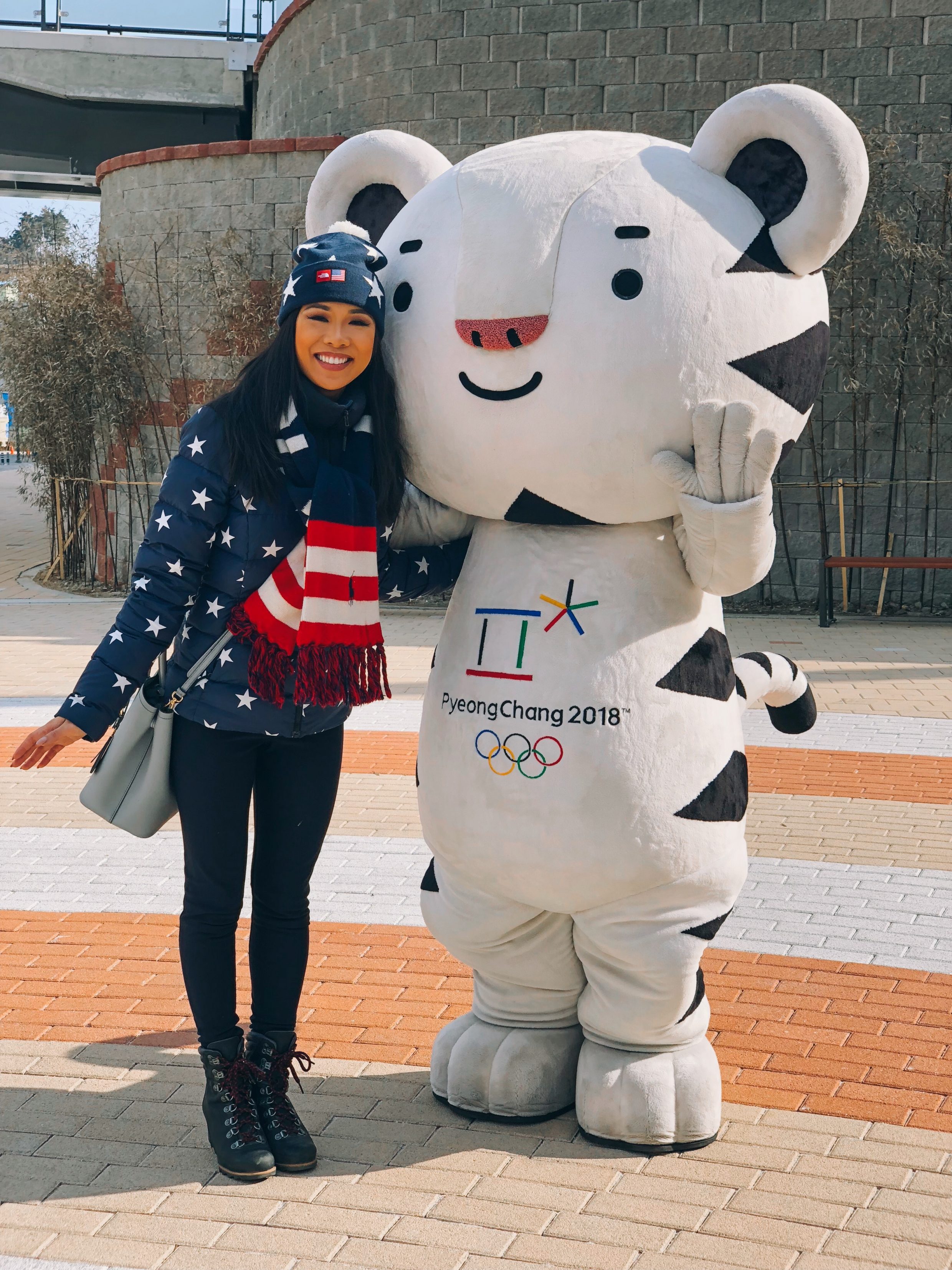 Hoang-Kim wearing The North Face Team USA Star Print Gear with Soohoorang, the PyeongChang 2018 Winter Olympics Mascot