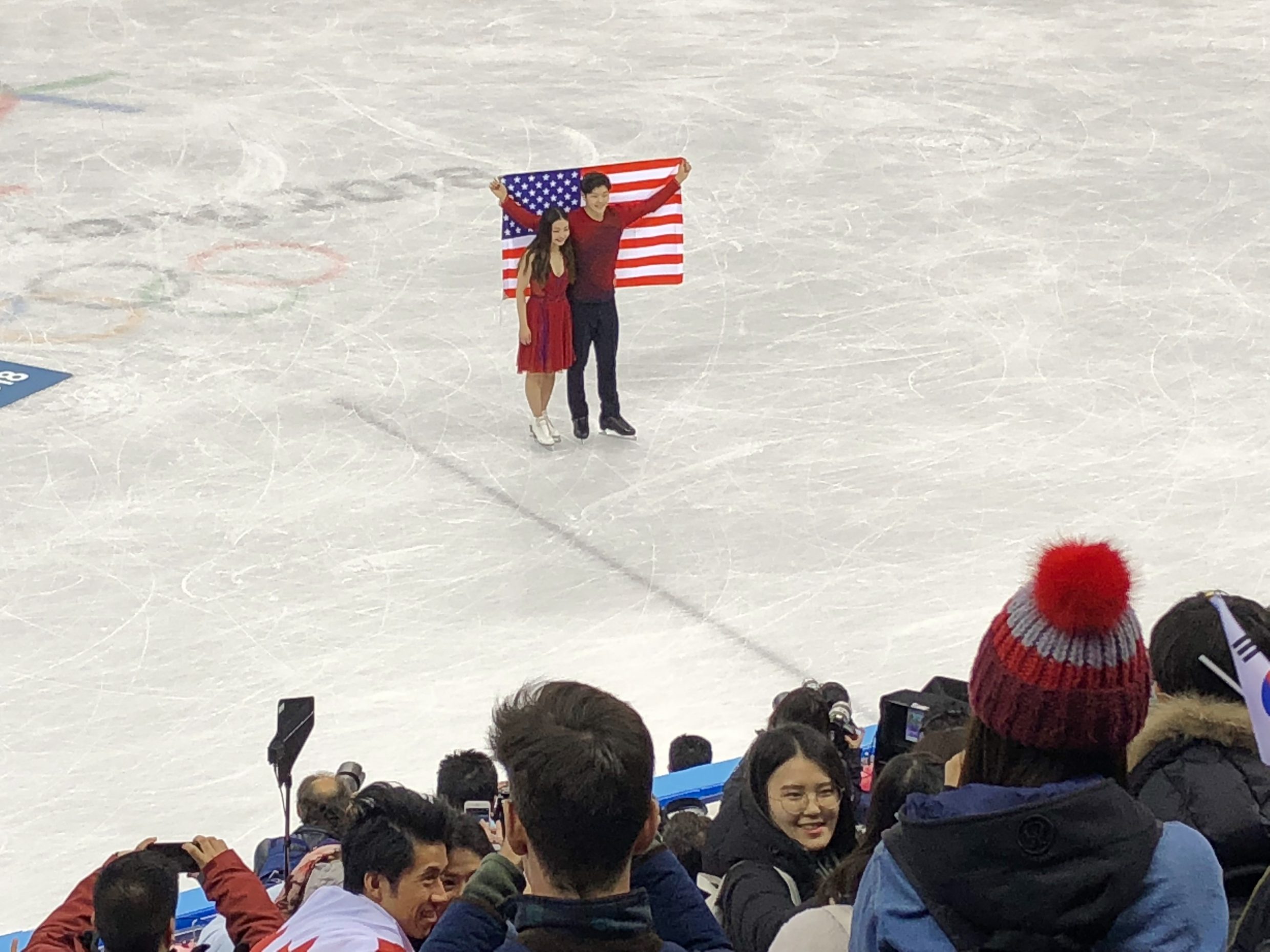 Maia and Alex Shibutani holds up the USA flag at the victory ceremony at Gangneung Ice Arena