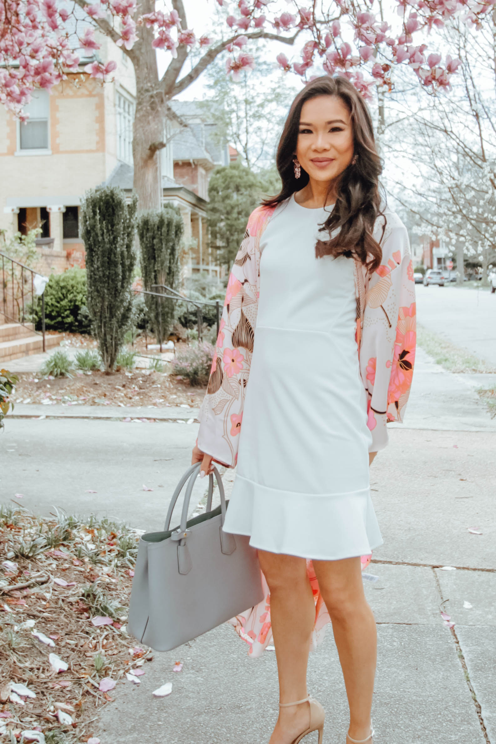 Blogger Hoang-Kim wears a white ruffle sleeve dress and floral kimono