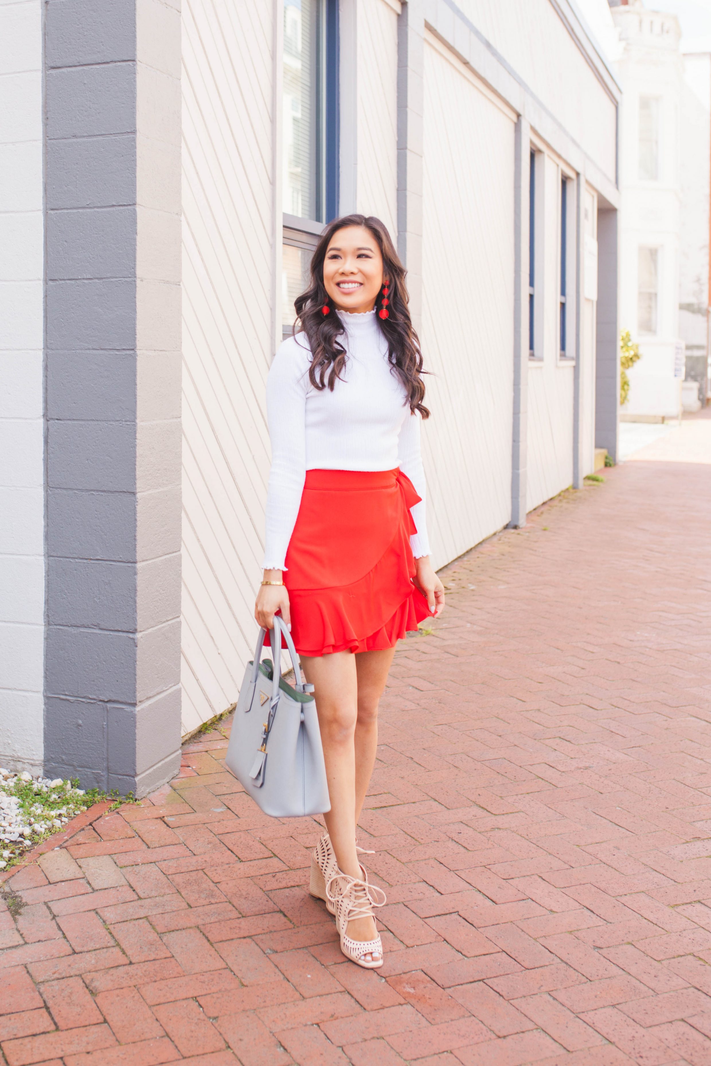 Red ruffle wrap skirt with wedges and ball drop earrings
