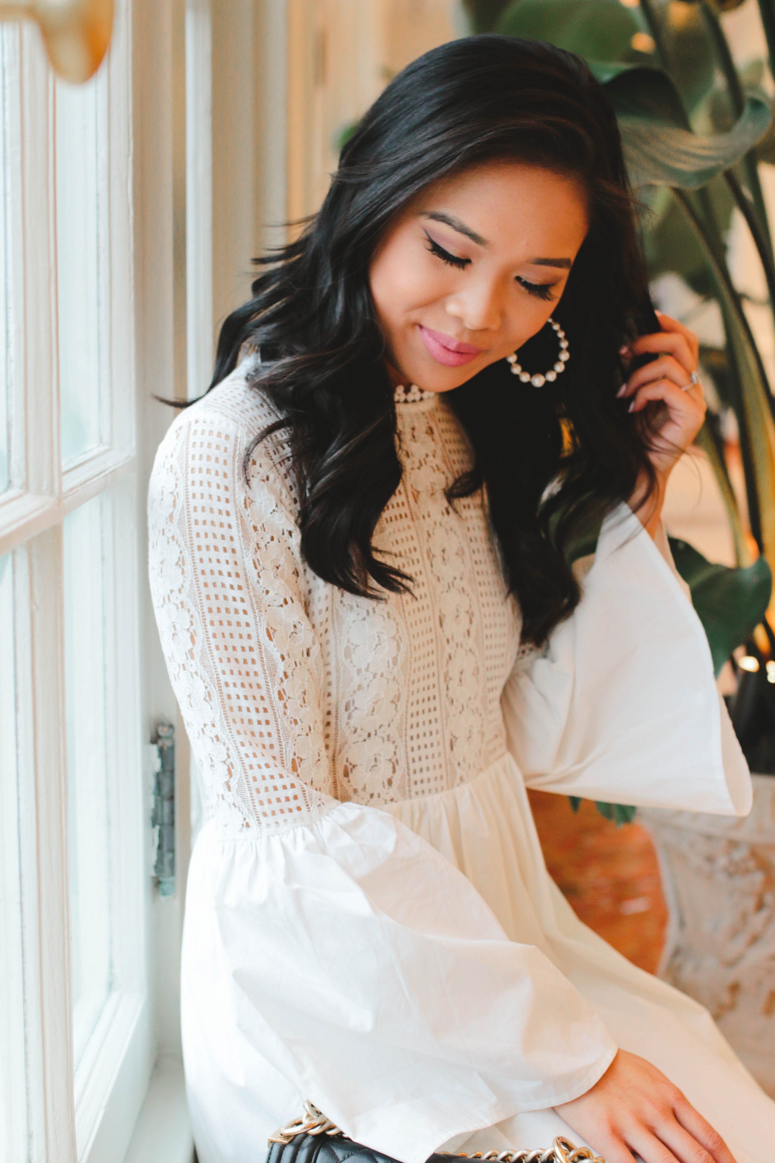 Hoang-Kim wears a white lace dress with olive + piper pearl hoop earrings at The Cavalier Hotel in Virginia beach