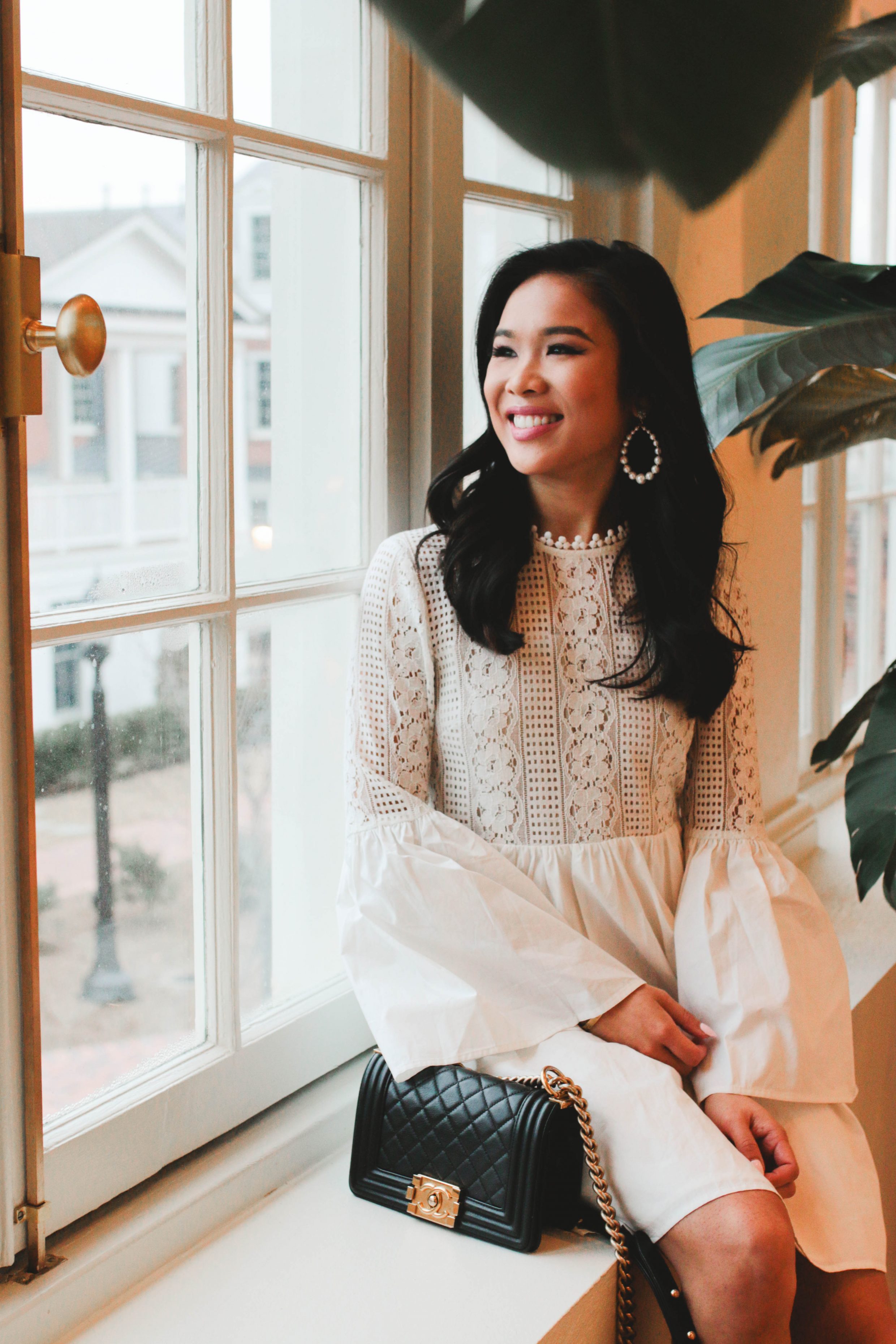Hoang-Kim wears a white lace dress with olive + piper pearl hoop earrings at The Cavalier Hotel in Virginia beach