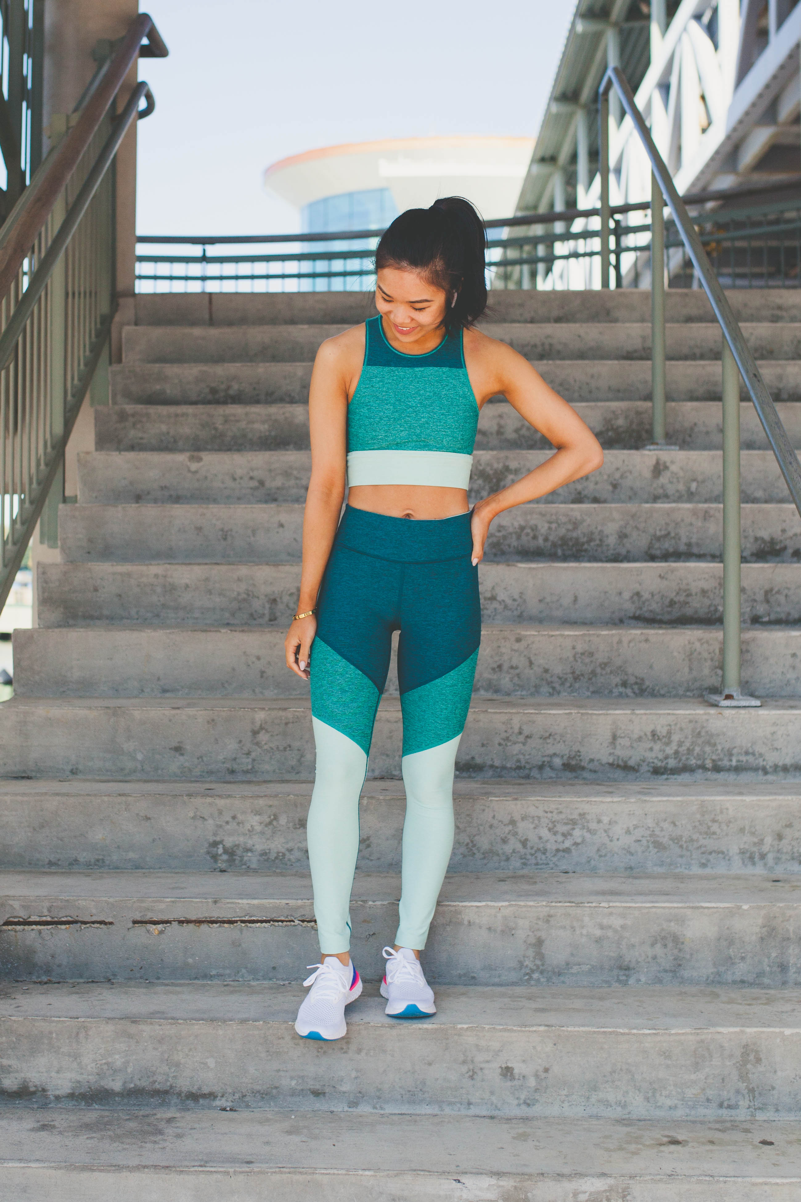 Hoang-Kim wears a matching colorblock workout set and Nike Epic React Flyknit Sneakers