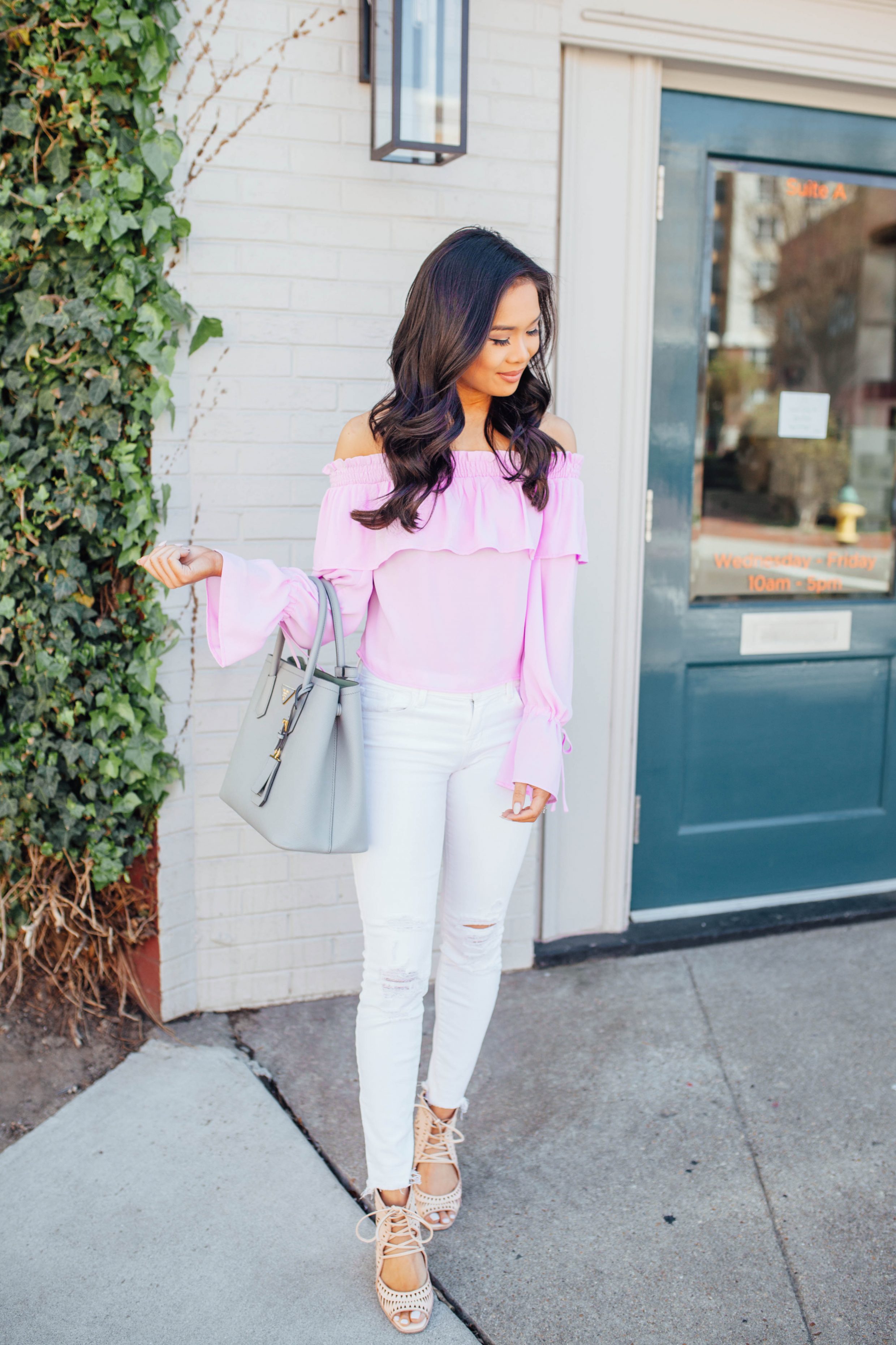 Hoang-Kim wears a lavender off-the-shoulder top with white jeans and wedges for spring
