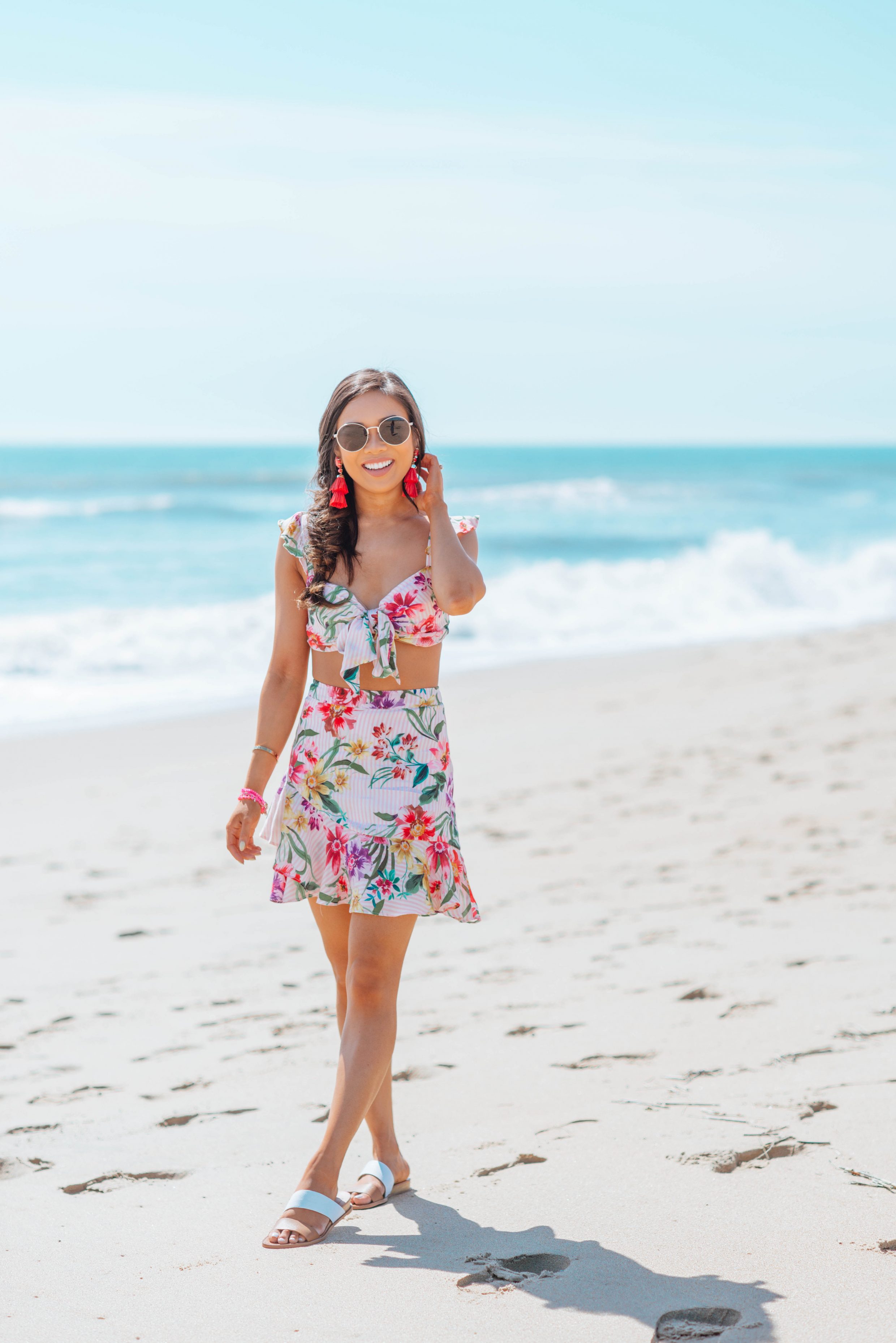 Blogger Hoang-Kim wears a floral two piece set with tassel earrings and a fishtail braid for the beach