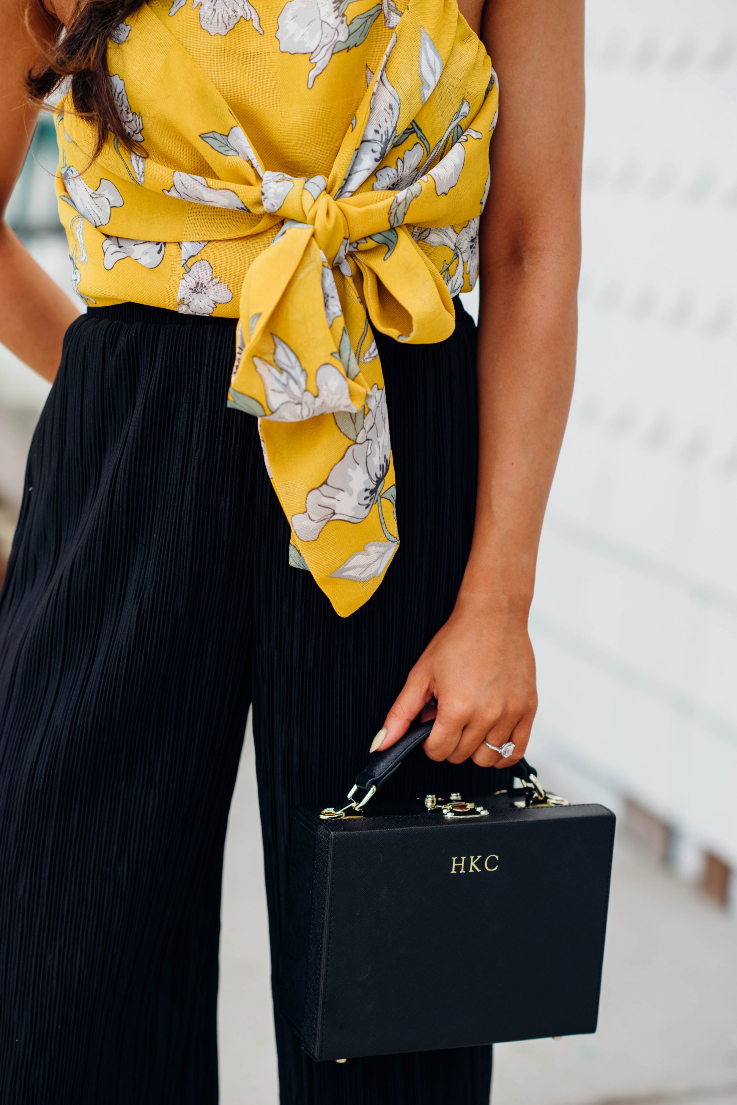 Yellow crop top with black wide-leg pants and box bag