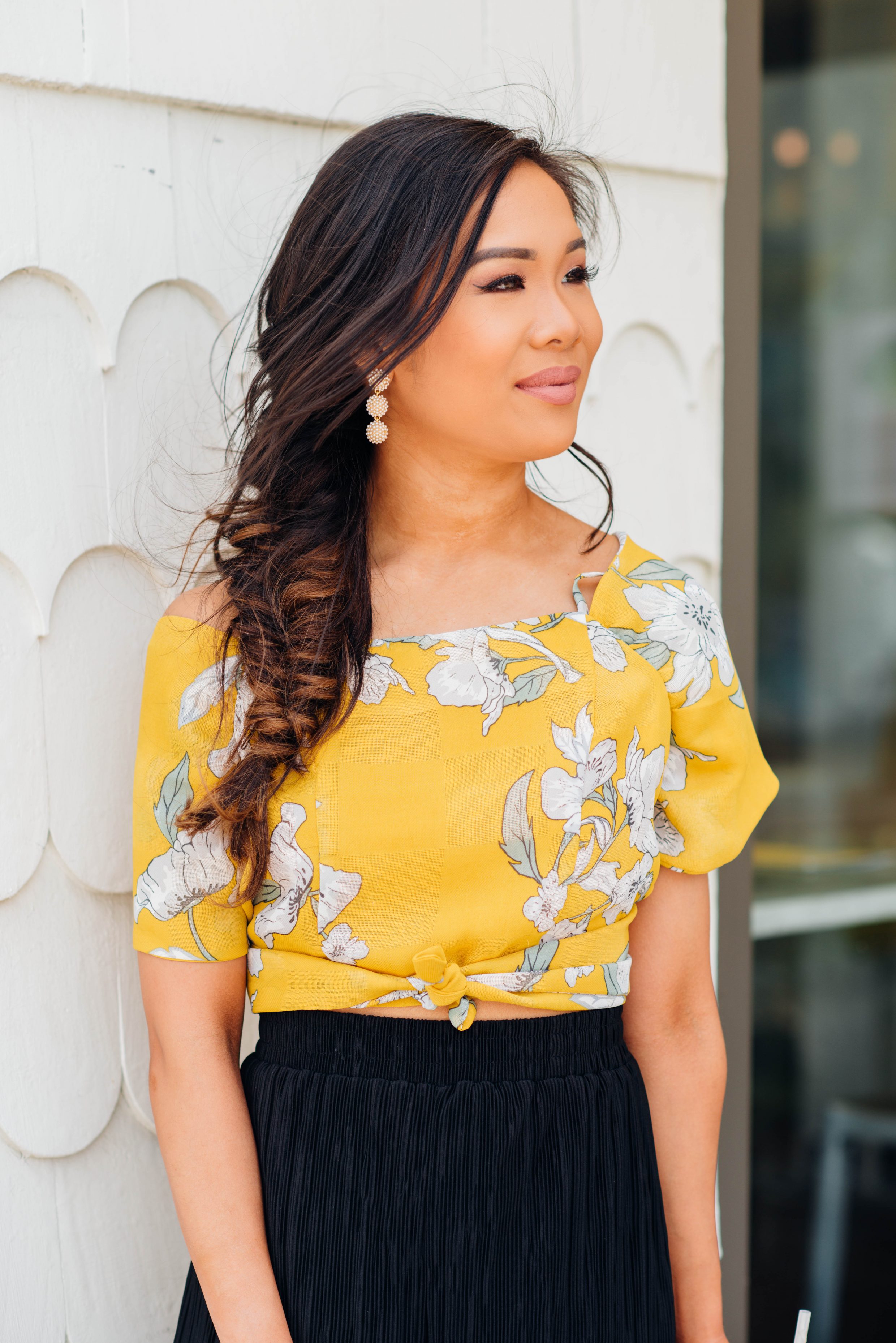 Hoang-Kim wears a JOA Tie-front crop top with Olive + Piper pearl earrings and a fishtail braid