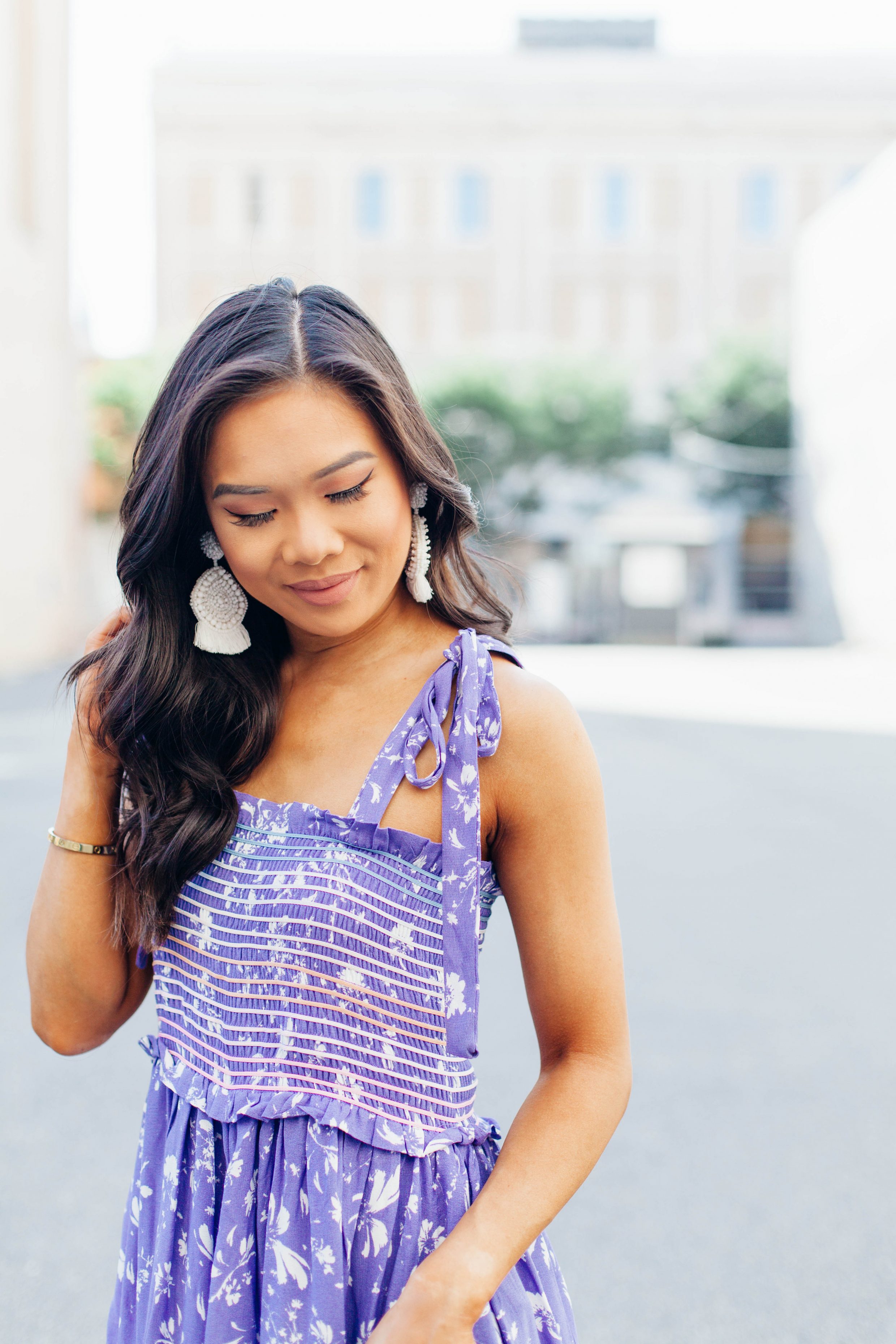 Purple wide leg floral jumpsuit and white beaded earrings