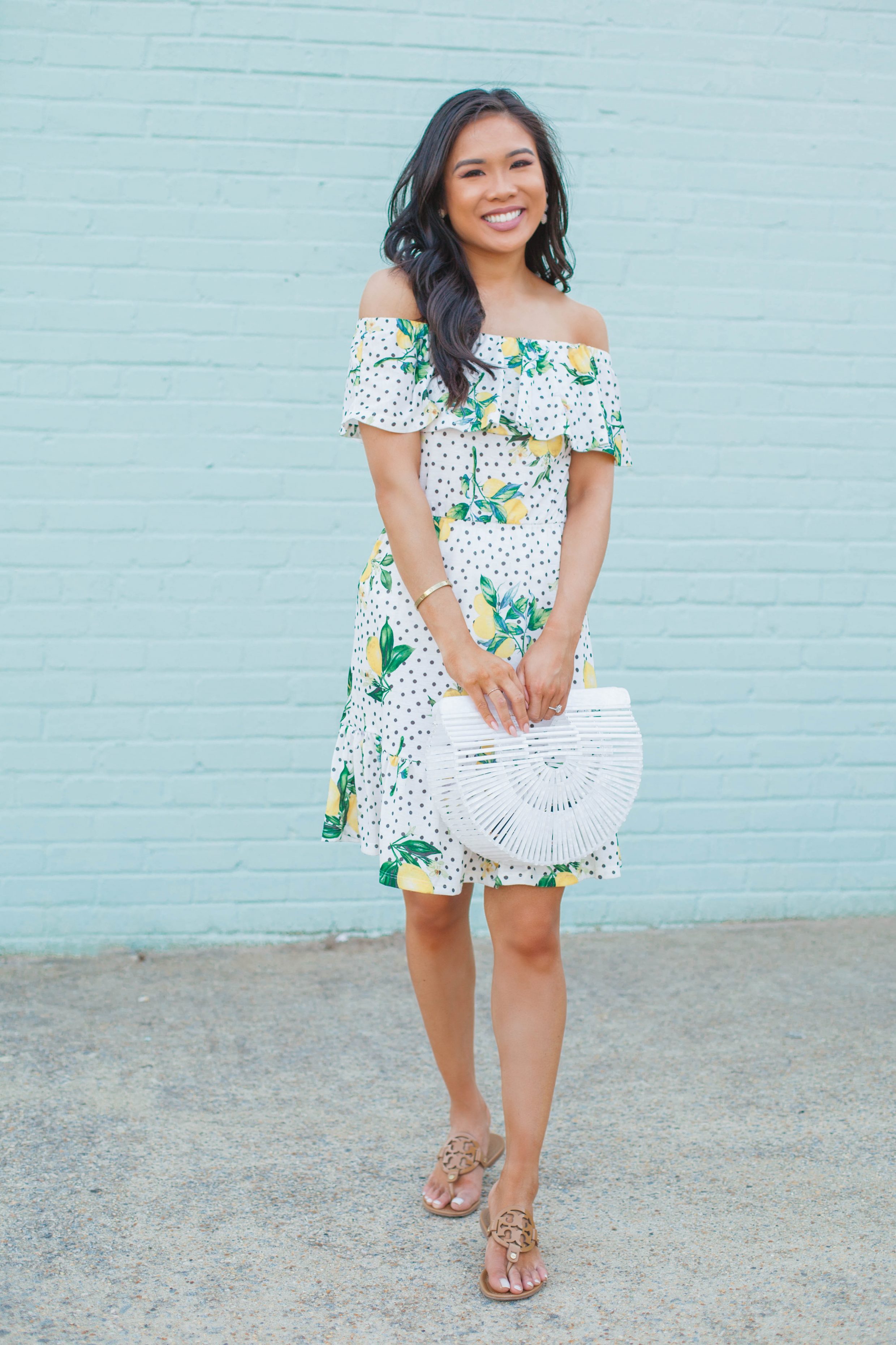 Off the shoulder lemon print dress with a white acrylic bag for summer