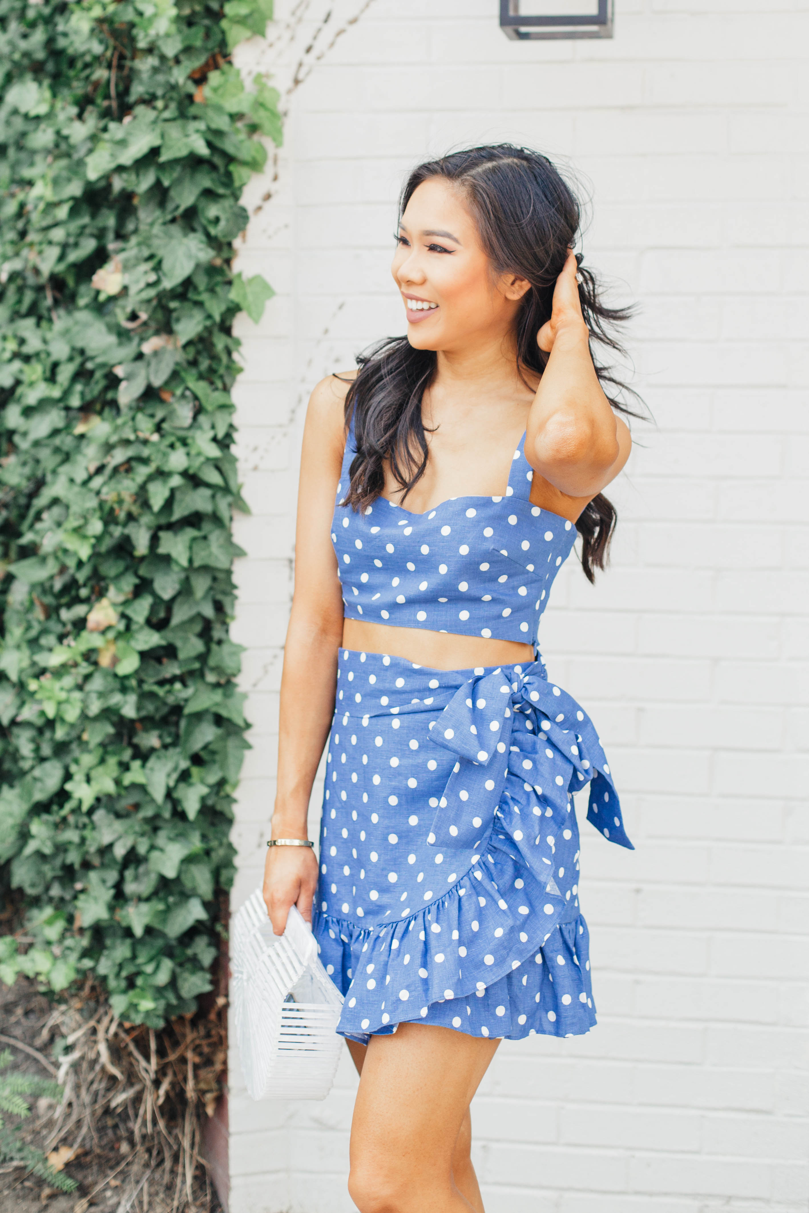 Blue polka-dot two piece set with white acrylic bag and suede sandals for a summer outfit