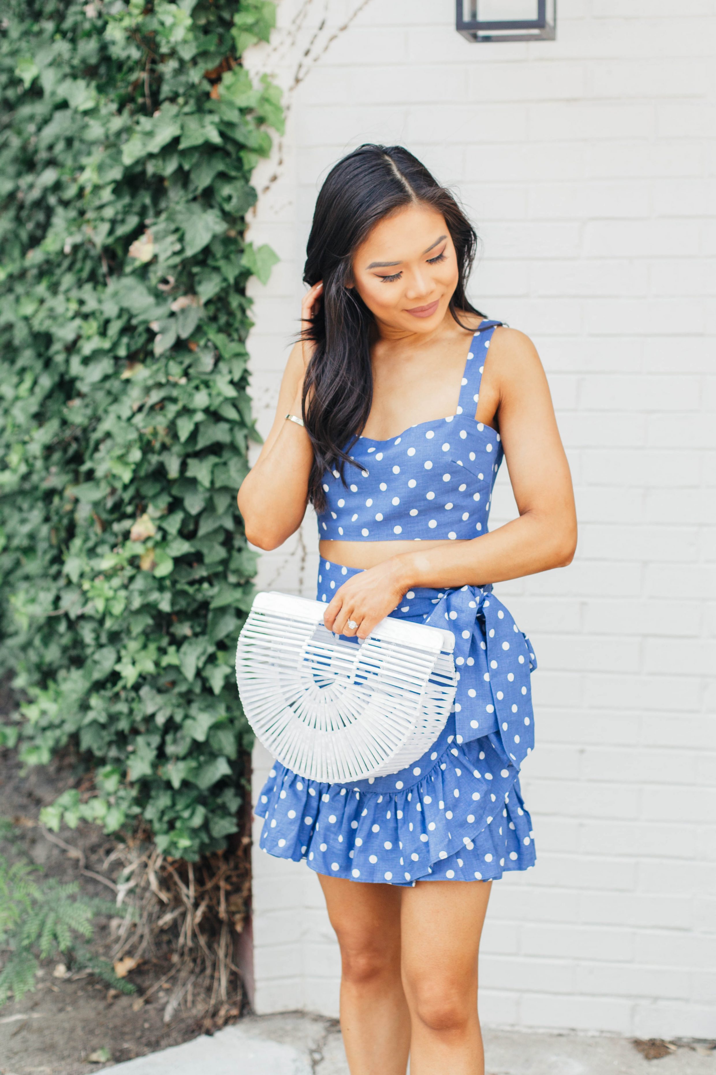 Blue polka-dot two piece set with white acrylic bag and suede sandals for a summer outfit