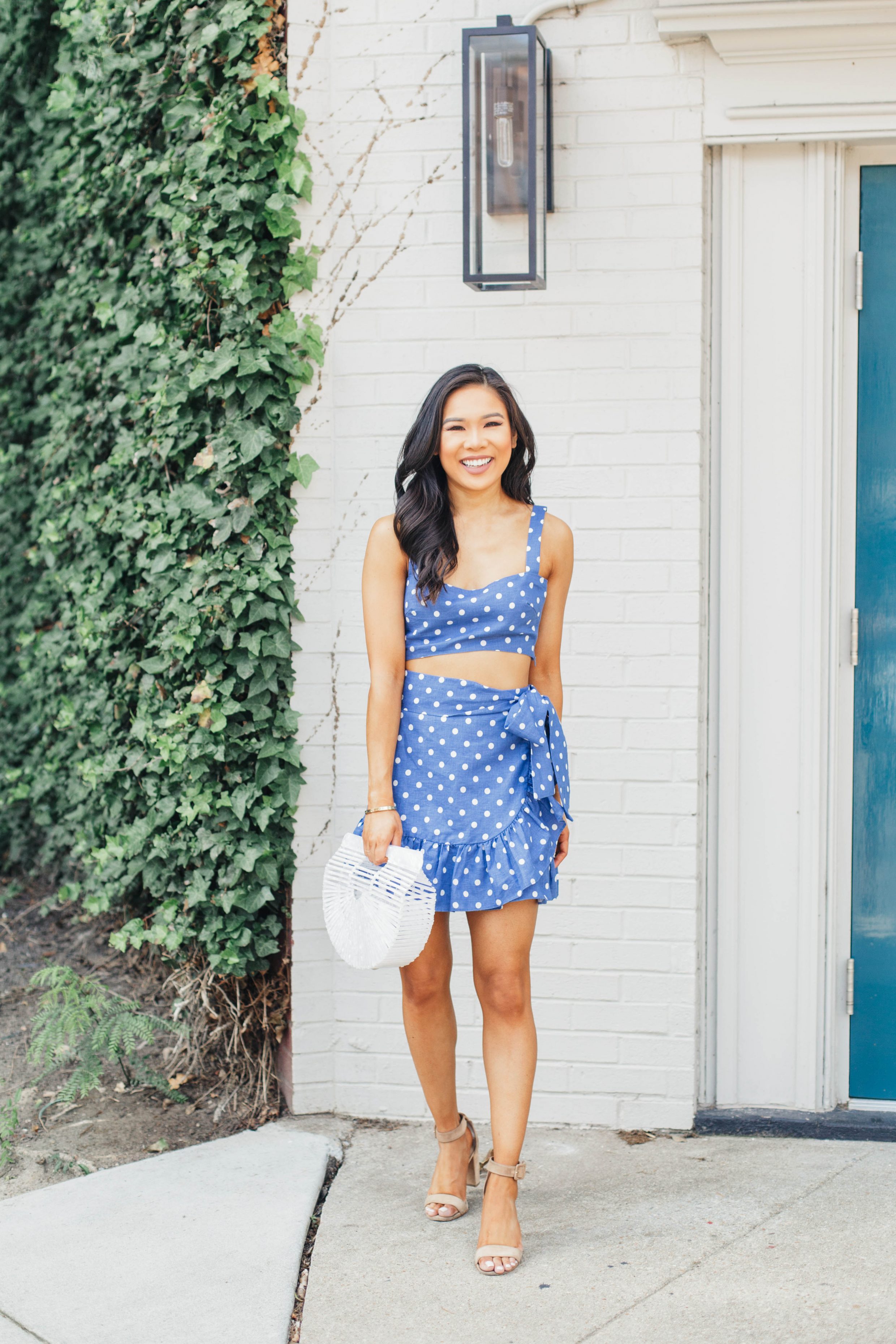 Blue polka-dot two piece set with white acrylic bag and suede sandals