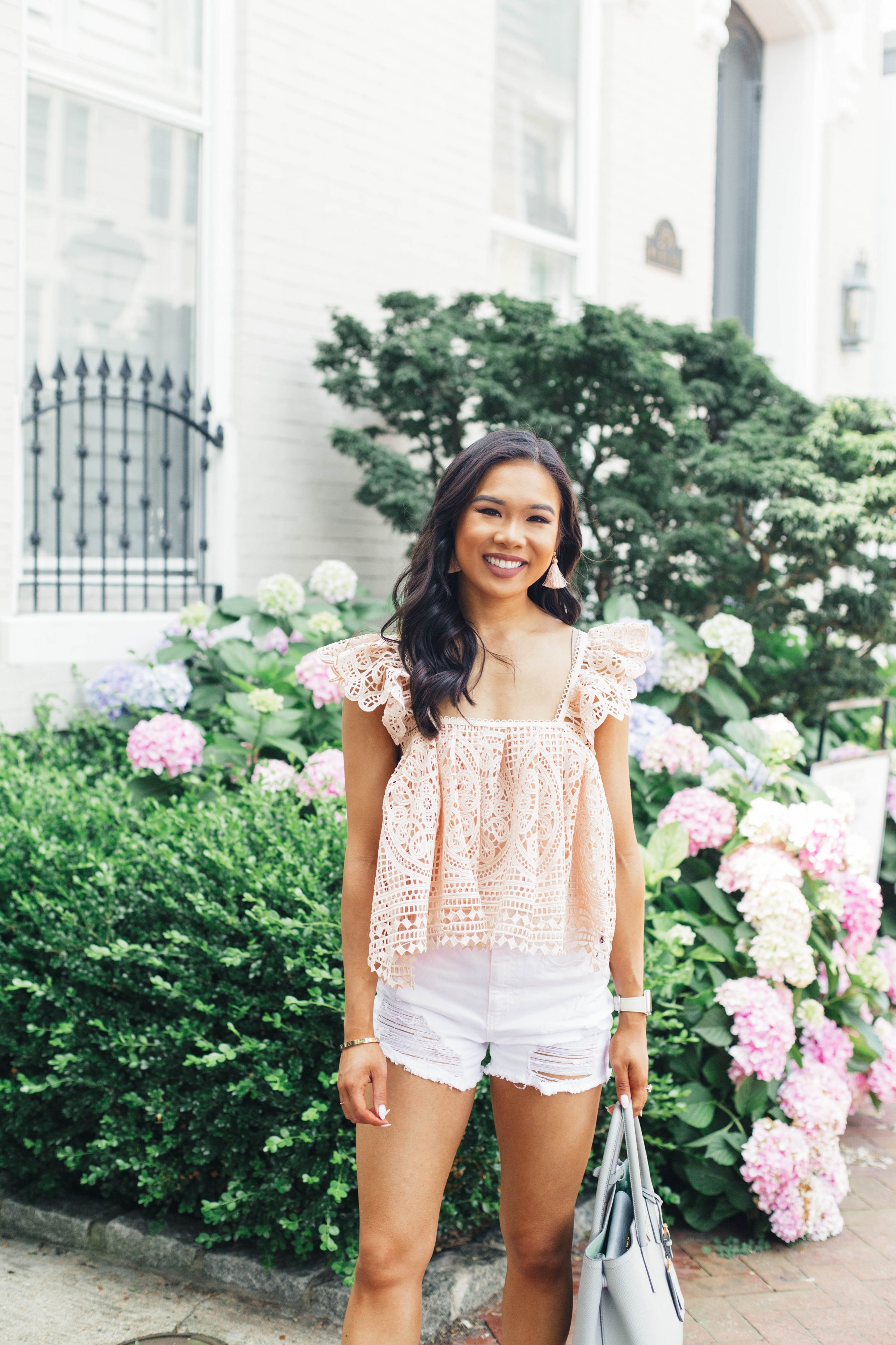 Pink crochet cropped top and white distressed shorts