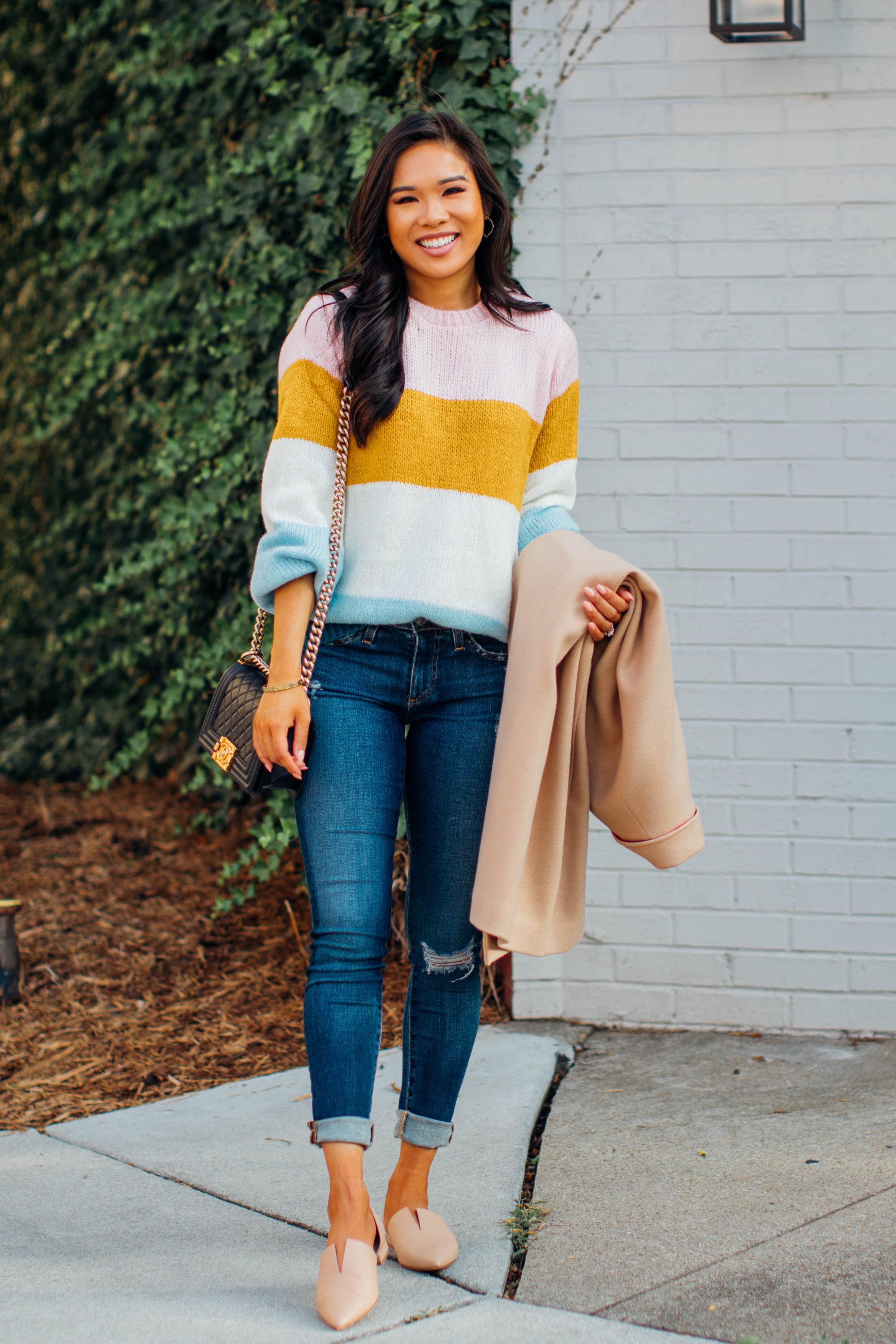 Blogger Hoang-Kim wears a striped transition sweater for fall