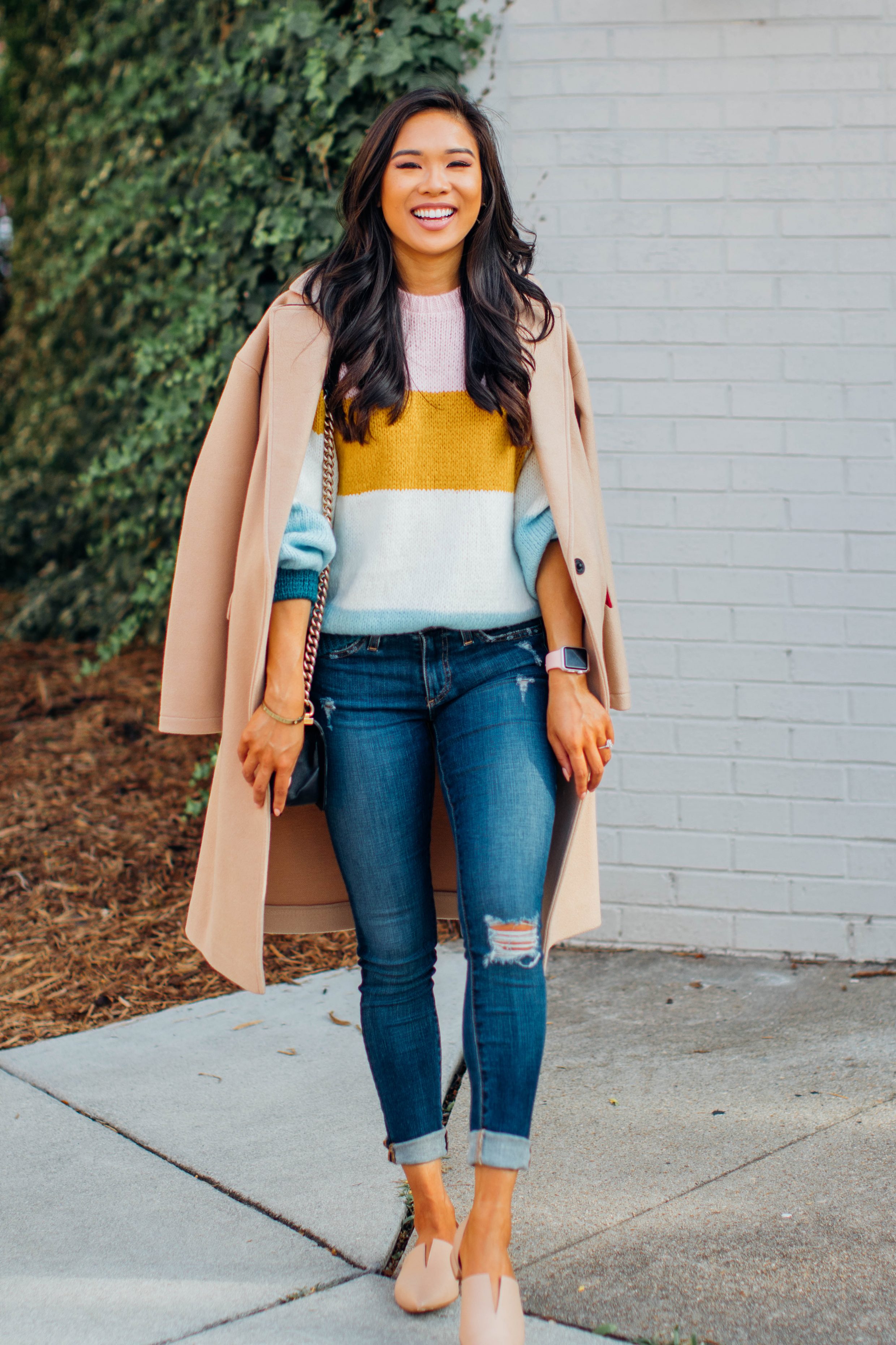 Blogger Hoang-Kim wears a striped transition sweater for fall