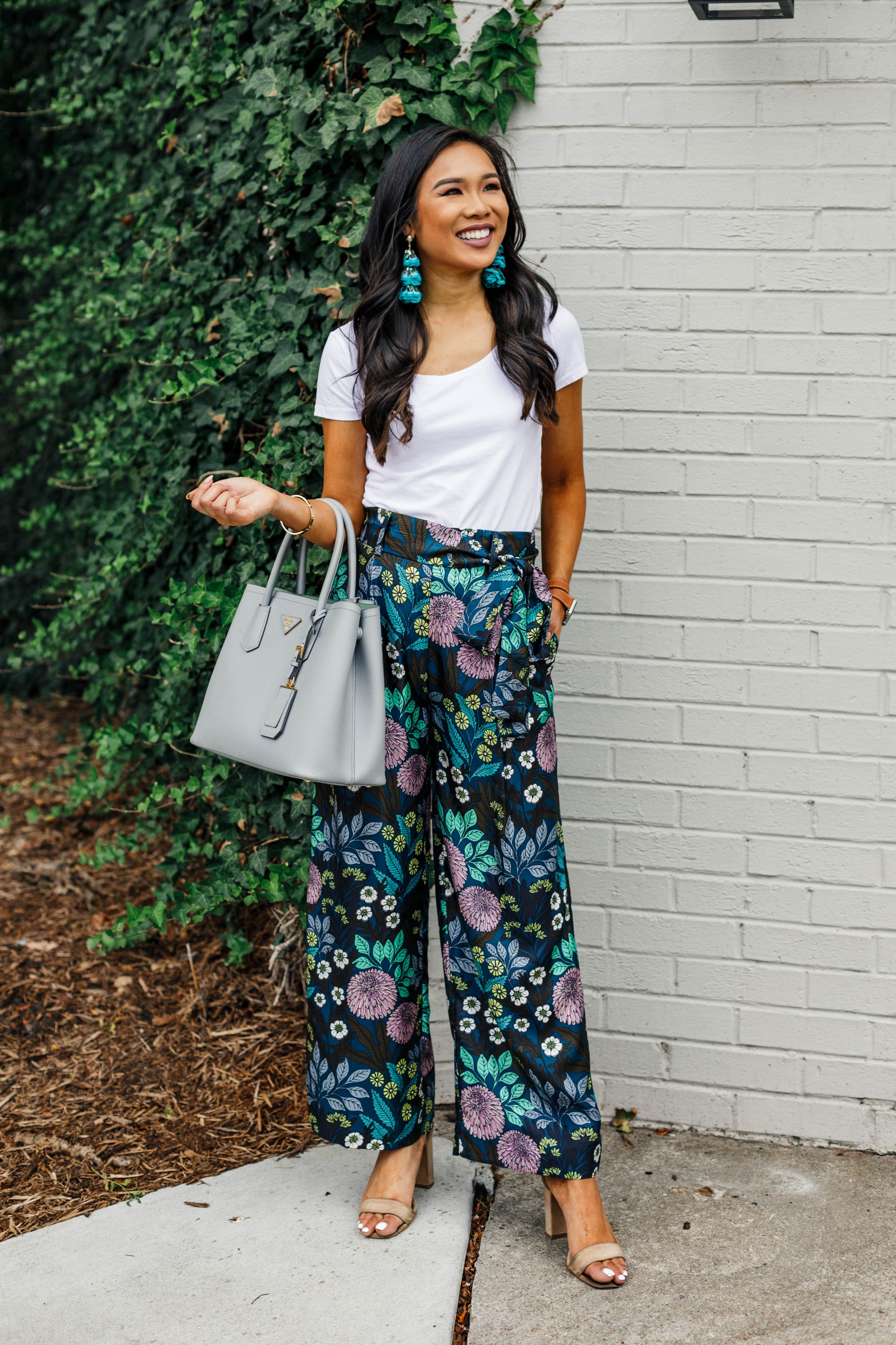 Blogger Hoang-Kim styles a pair of silk wide-leg pants with teal feather earrings