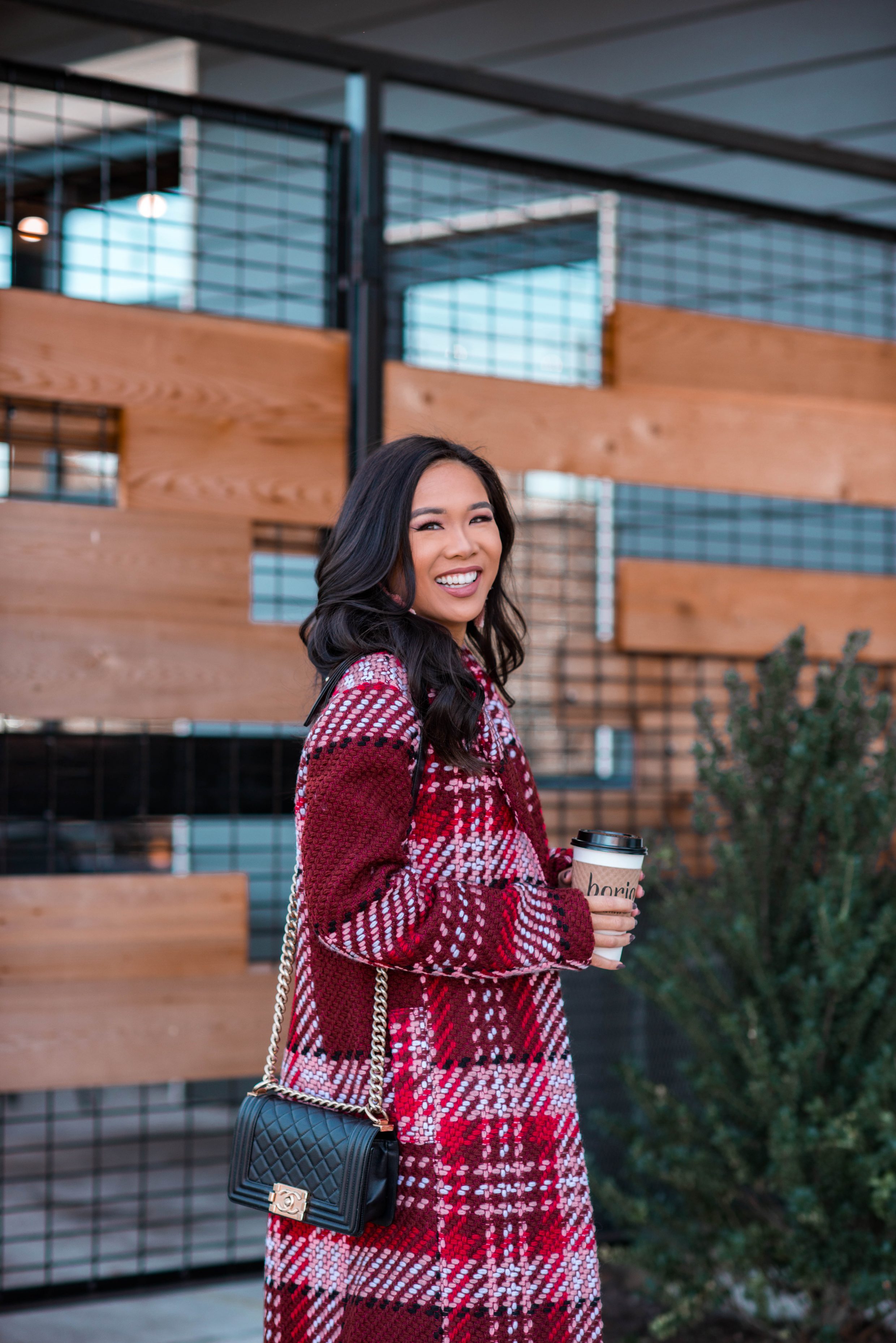 Blogger Hoang-Kim styles a plaid statement coat with a Chanel boy bag for winter