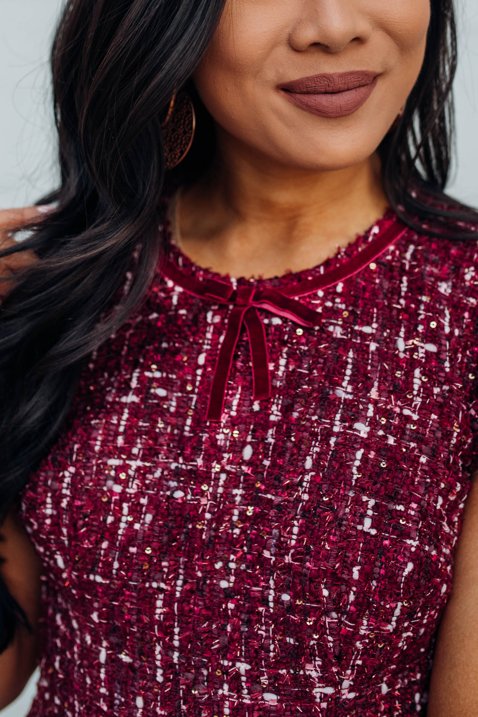Blogger Hoang-Kim wears a tweed dress with velvet for a holiday outfit idea