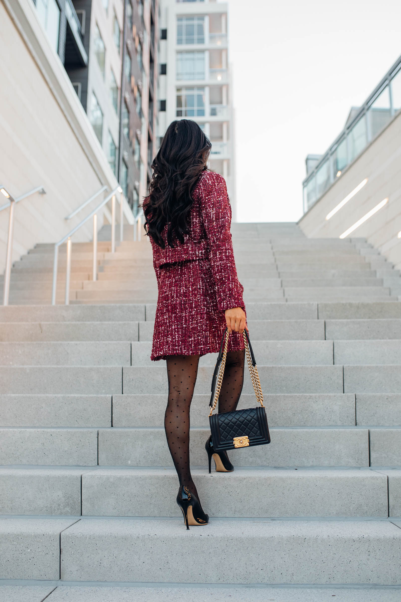 Blogger Hoang-Kim shares an office holiday party outfit idea wearing a matching tweed dress and jacket