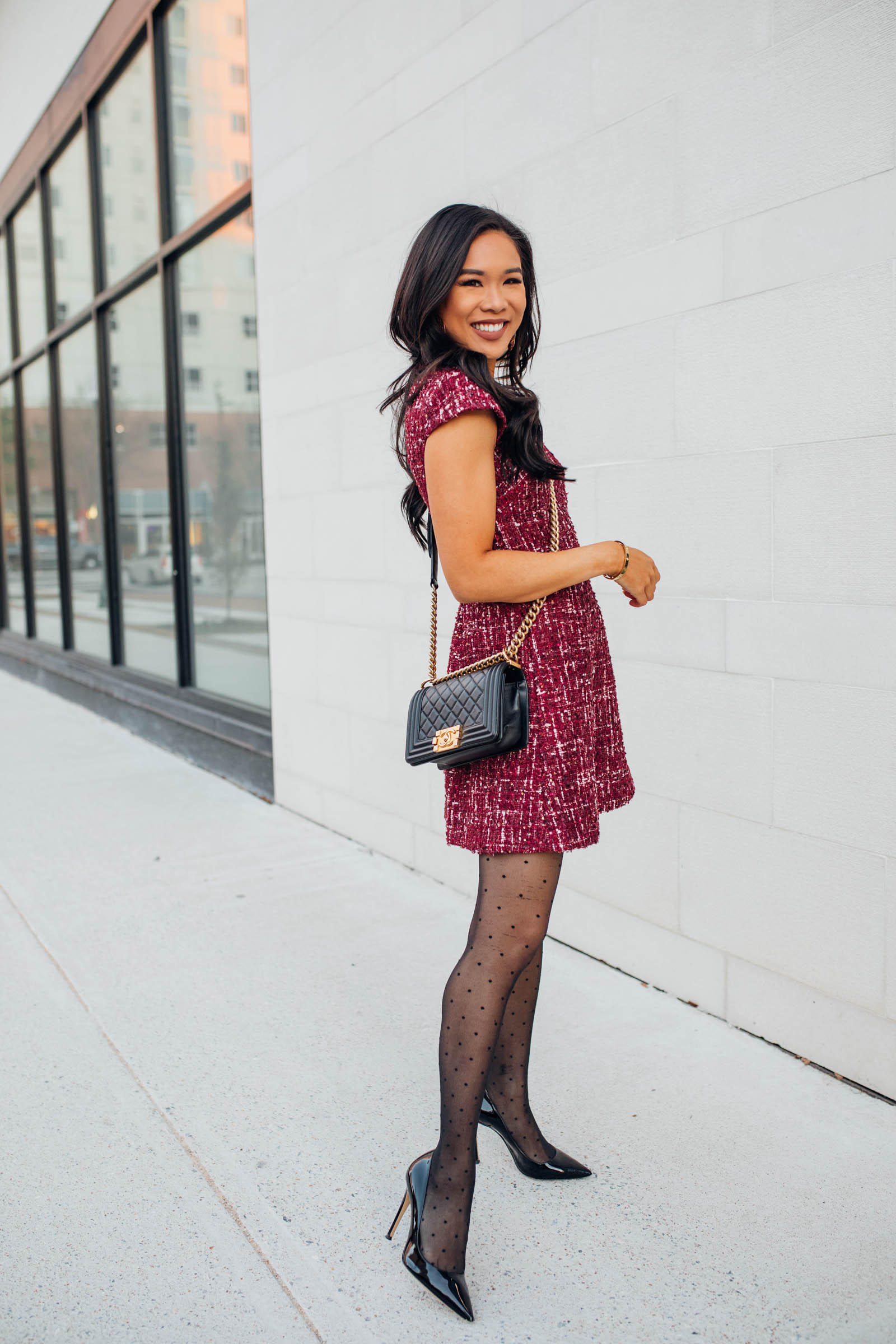 Blogger Hoang-Kim wears a tweed dress with velvet for a holiday party outfit idea