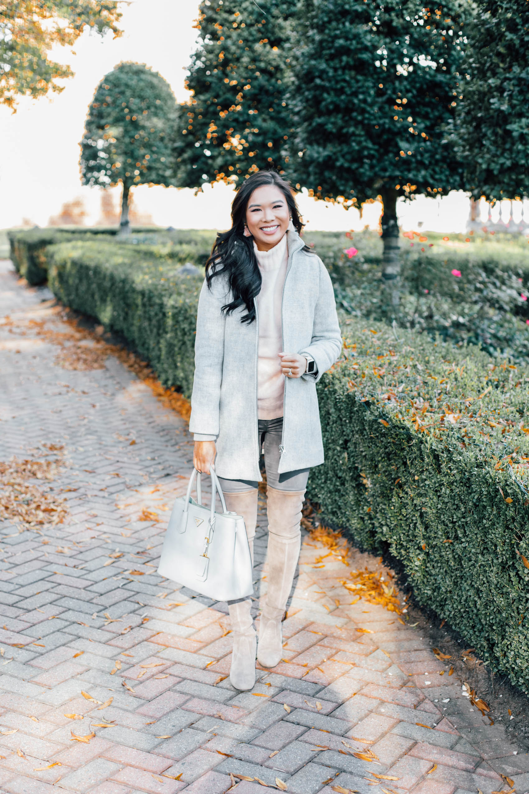 Hoang-Kim wears a wool coat for petite women with over-the-knee boots