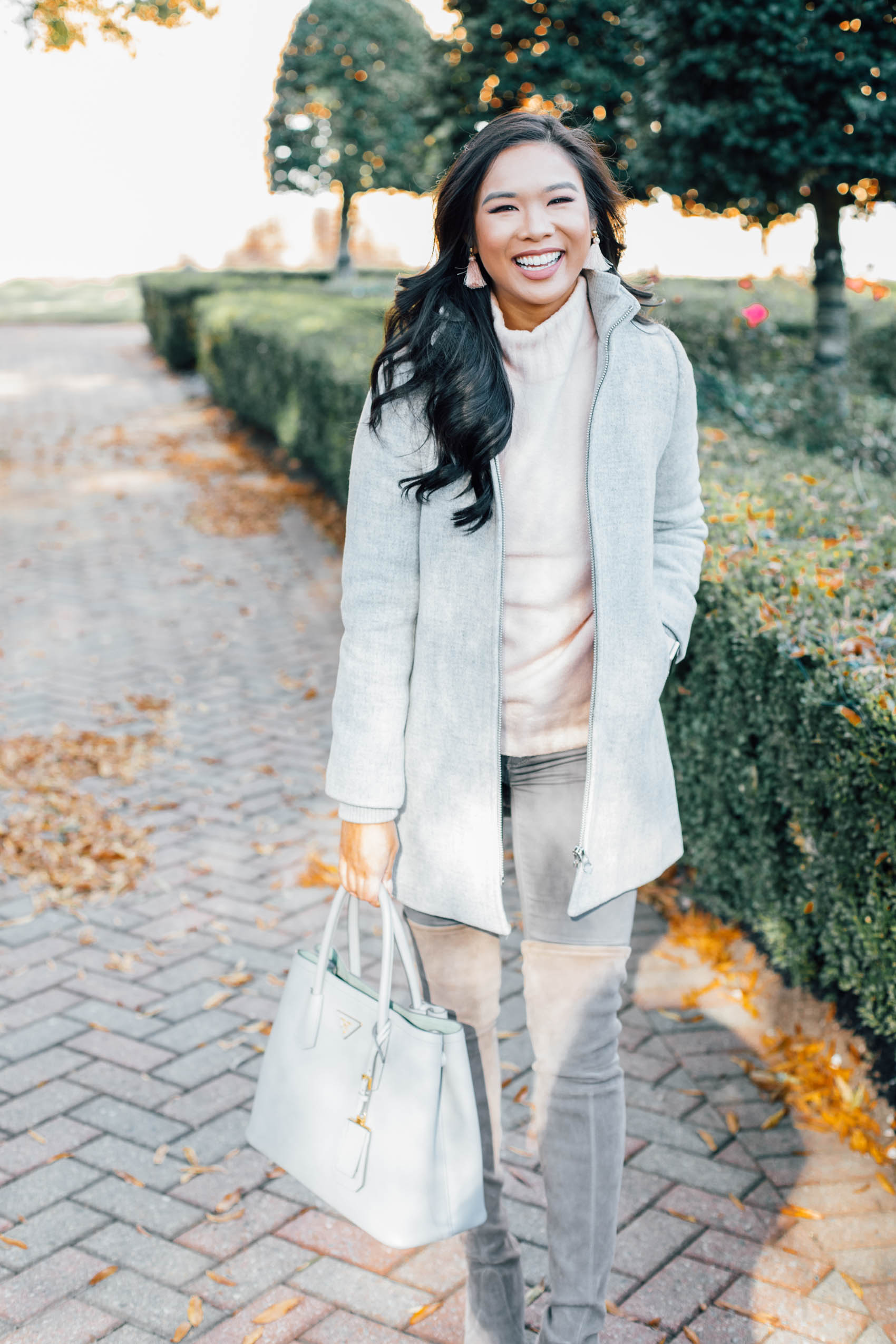 Hoang-Kim wears a wool coat for petite women with over-the-knee boots