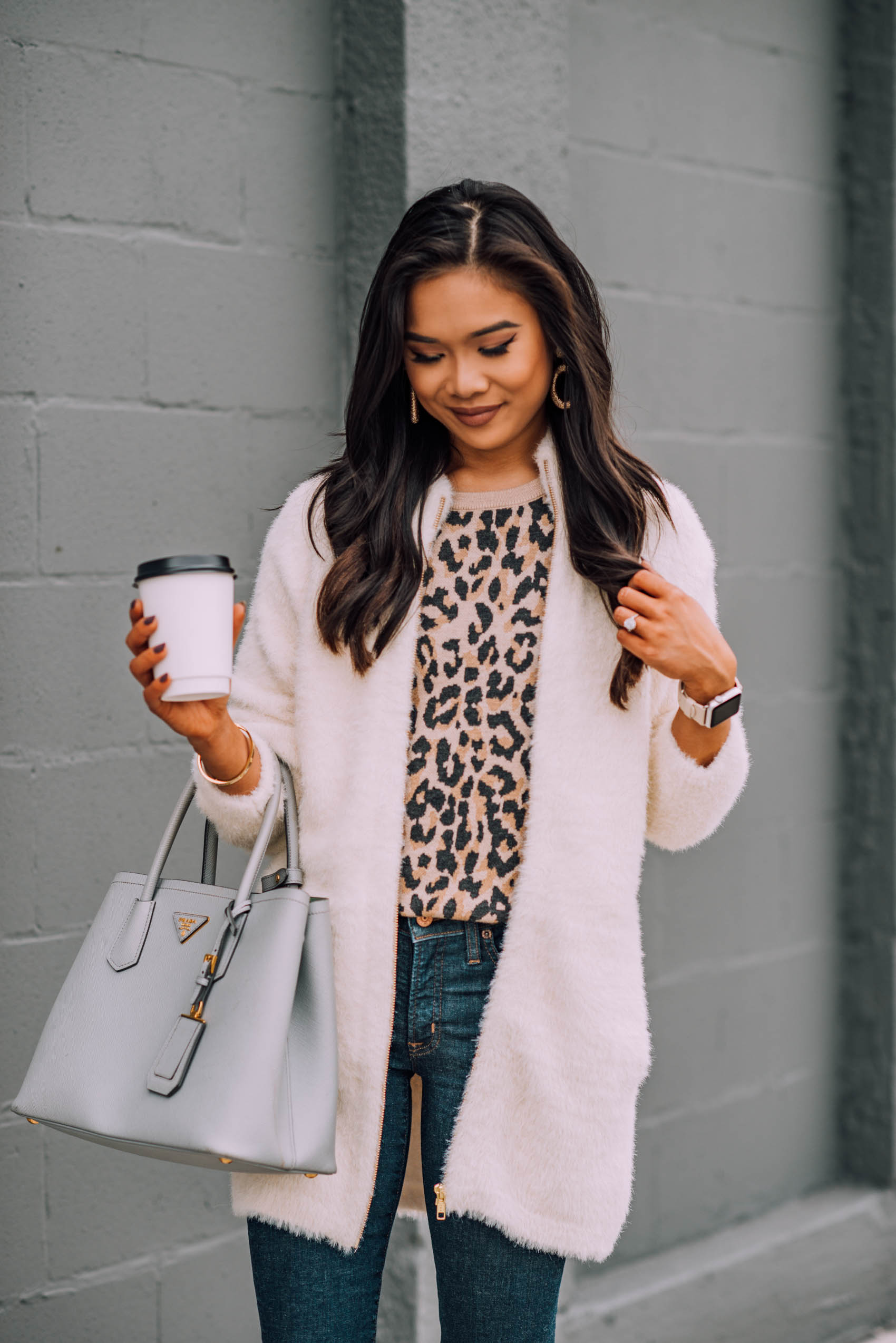 Blogger Hoang-Kim wears a fuzzy cardigan jacket with a leopard print sweatshirt for fall