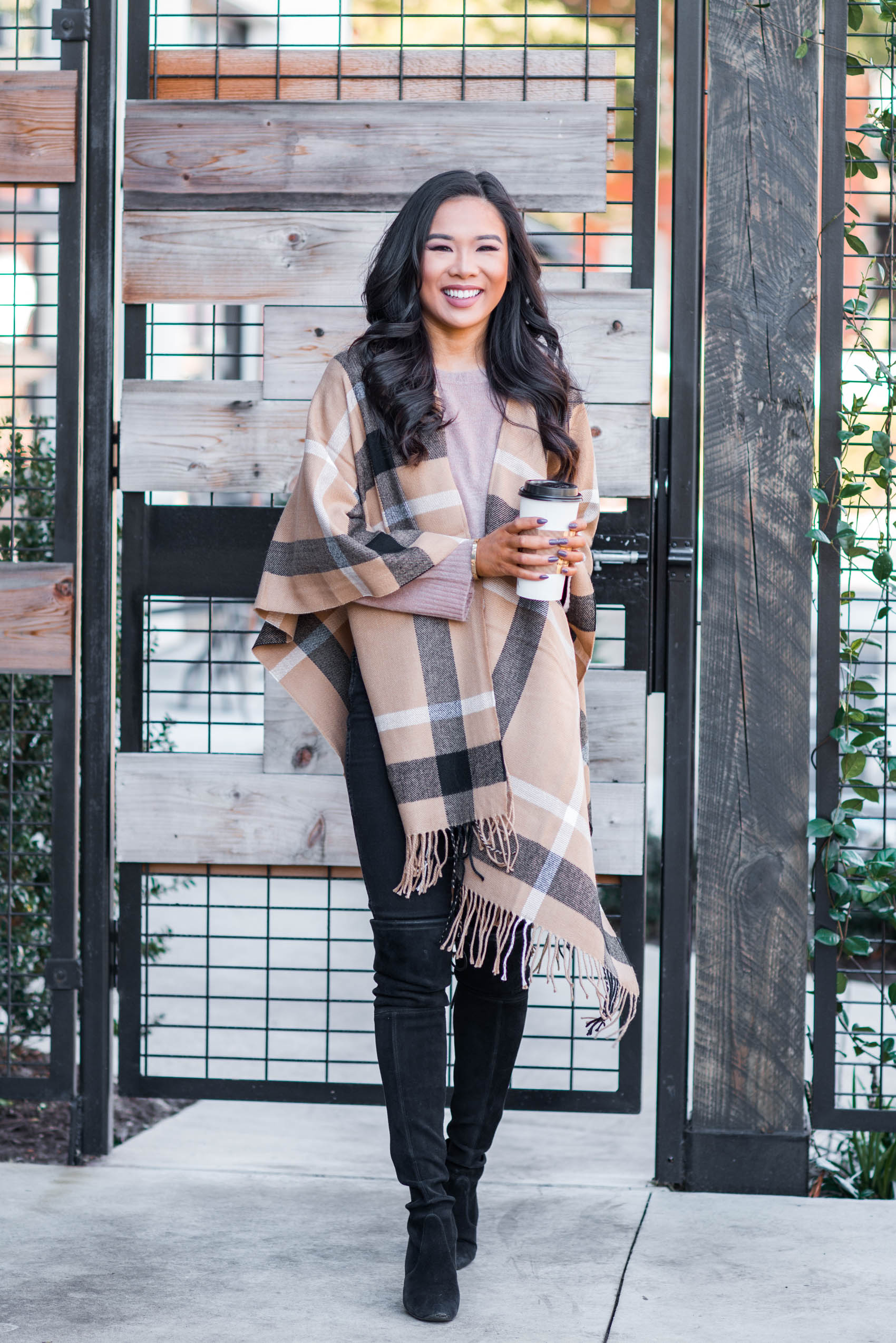 Blogger Hoang-Kim wears a plaid poncho as a practical gift to give for Christmas