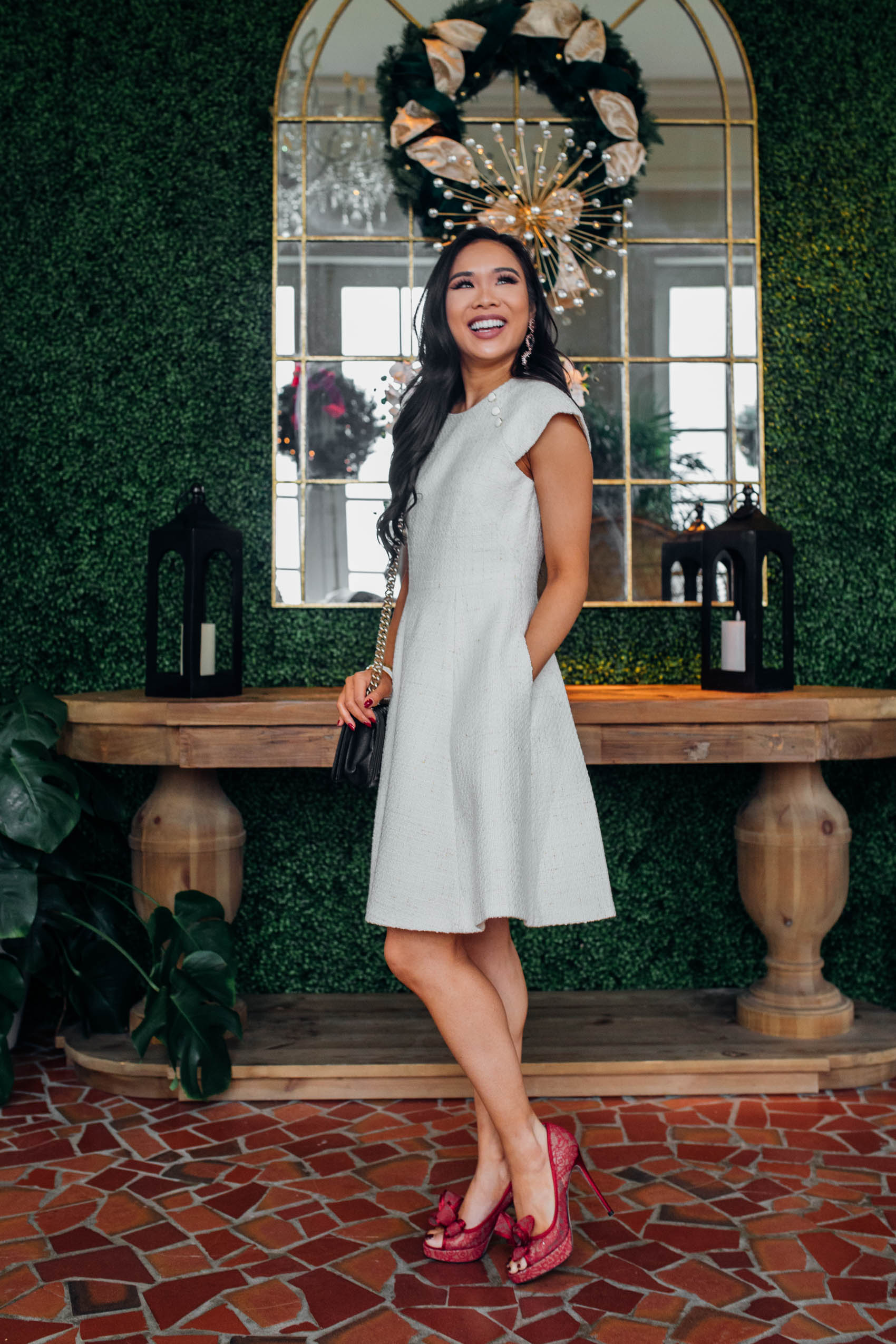 Blogger Hoang-Kim wears a Gal Meets Glam Emilie dress with red bow heels for the holidays