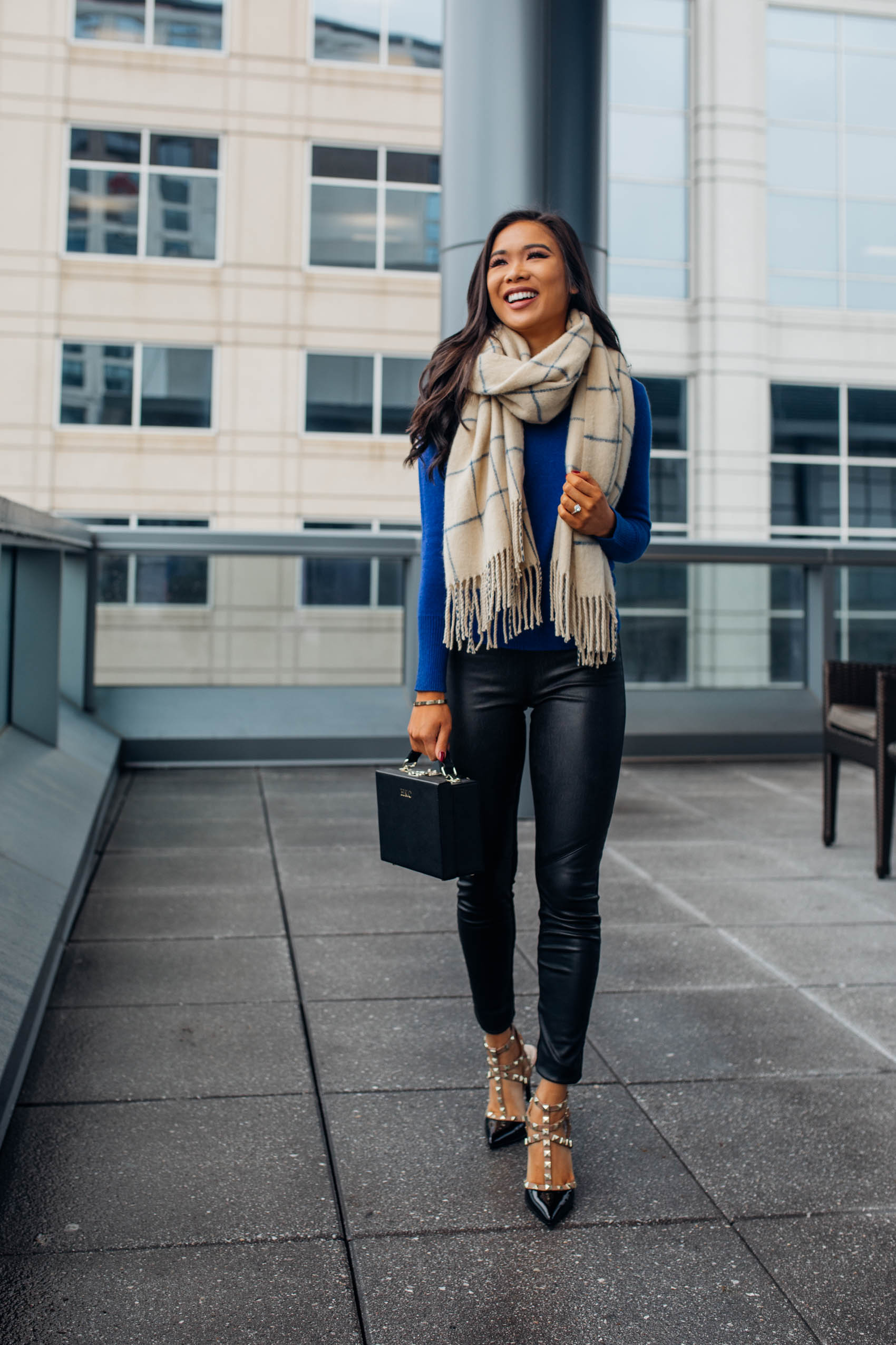 Hoang-Kim wears a cashmere scarf and sweater to stay warm