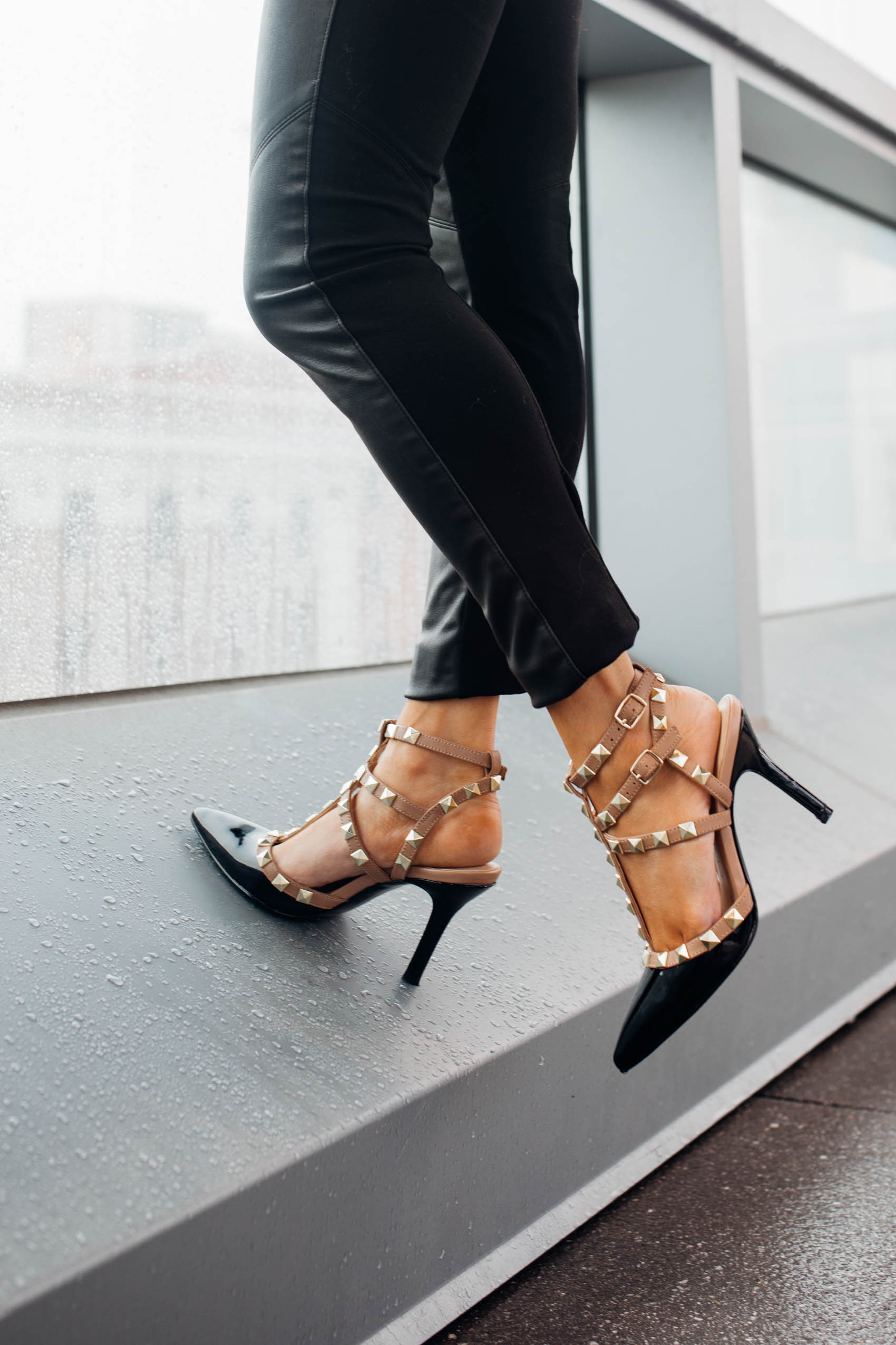 Blogger Hoang-Kim wears a pair of black patent leather studded strappy heels