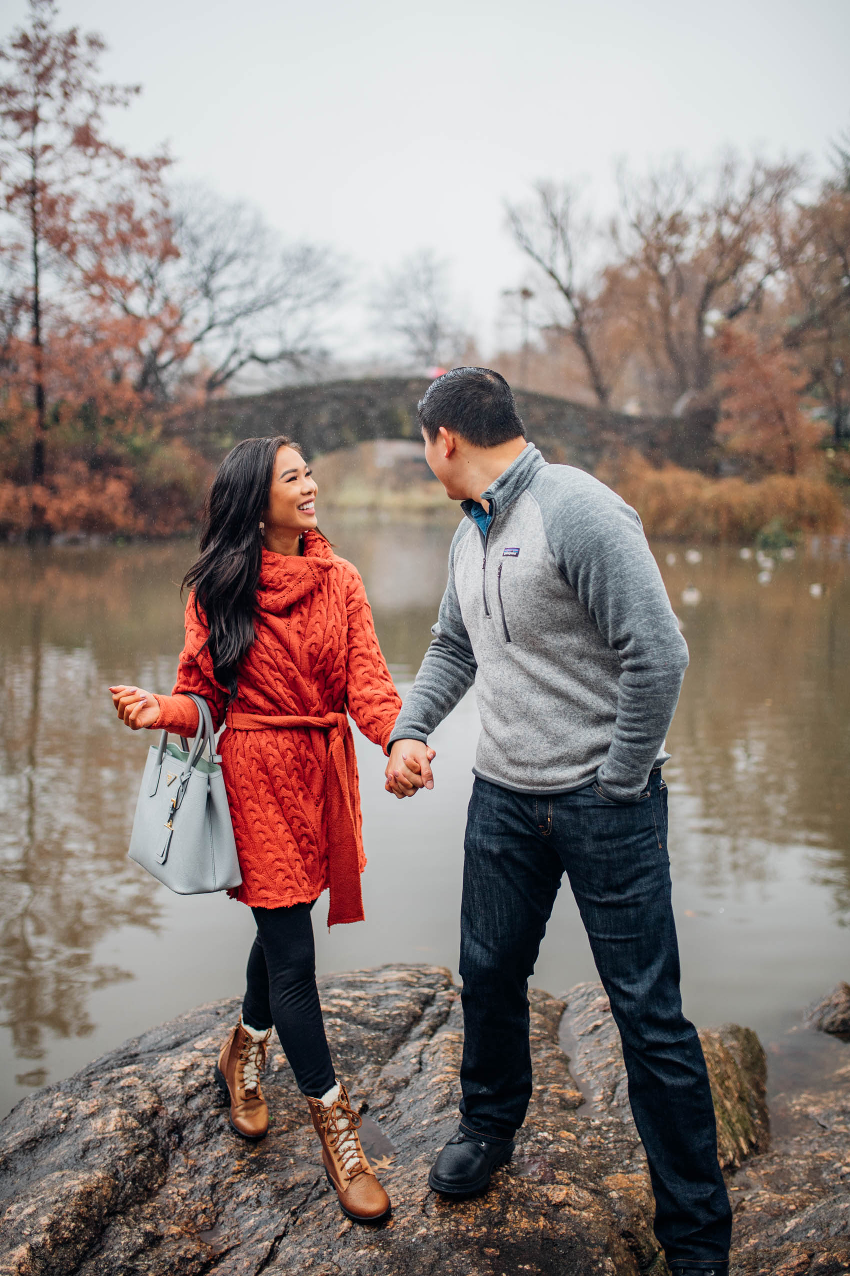 Blogger Hoang-Kim wears a red sweater dress with warm leggings and boots at Central Park during winter